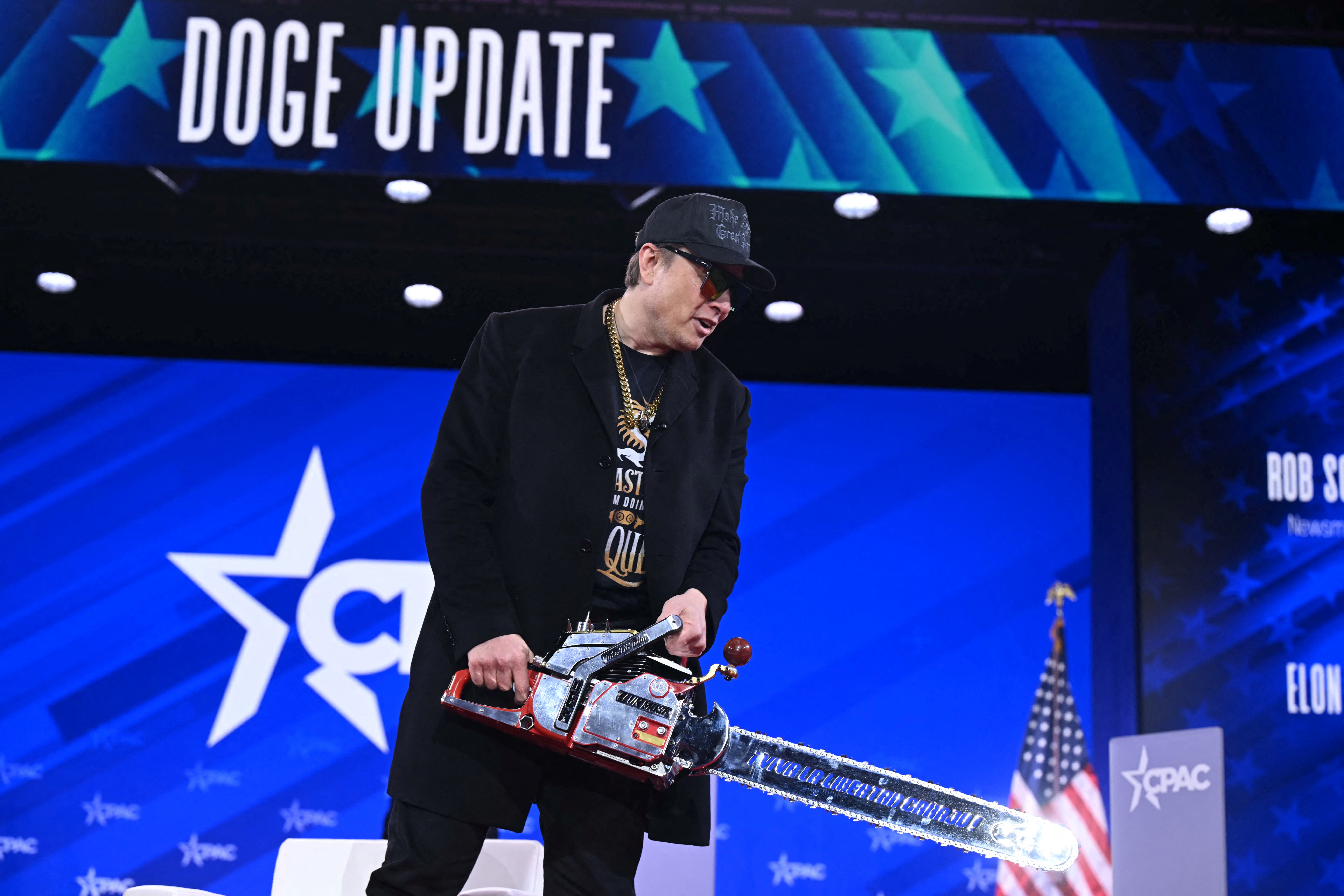 Elon Musk holds a chainsaw as he speaks at the annual Conservative Political Action Conference (CPAC) at the Gaylord National Resort & Convention Center at National Harbor in Oxon Hill, Maryland, on February 20, 2025 | Source: Getty Images