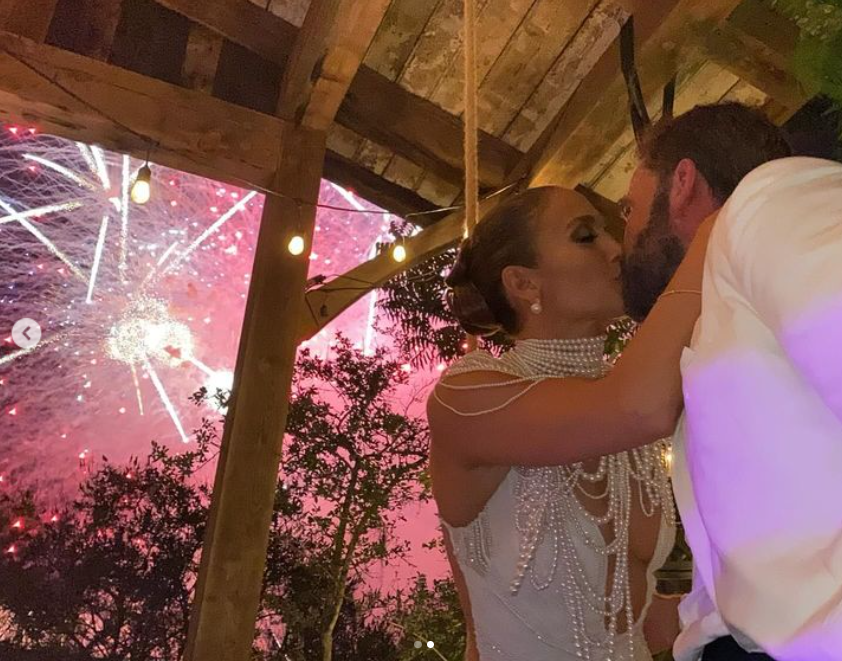 Jennifer Lopez and Ben Affleck shаrе a kiss on their wedding day, posted in August 2023 | Source: Instagram/jlo