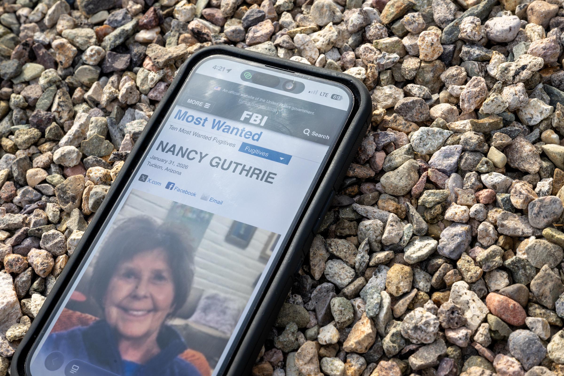 A photo of Nancy Guthrie on the FBI website on a cellular phone February 10, 2026 in Tucson, Arizona. | Source: Getty Images