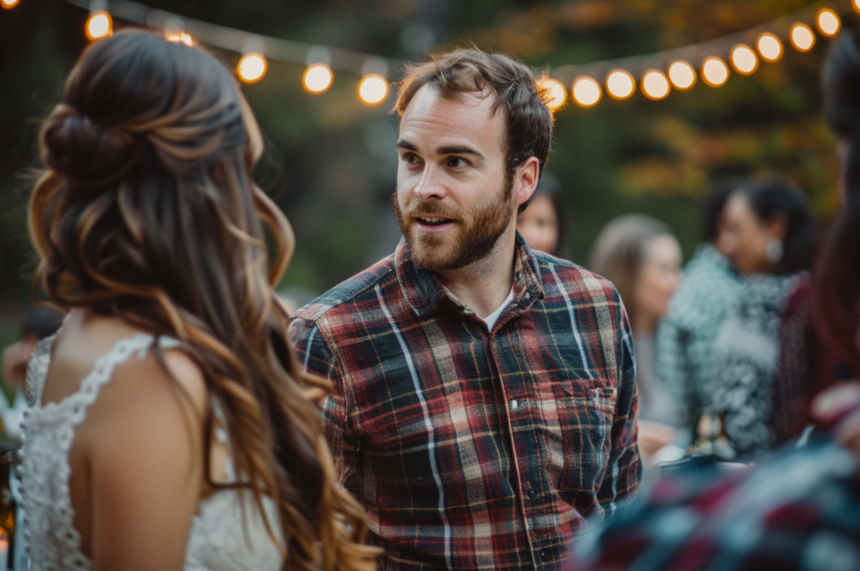 Casually dressed man speaking to the bride at a reception | Source: MidJourney