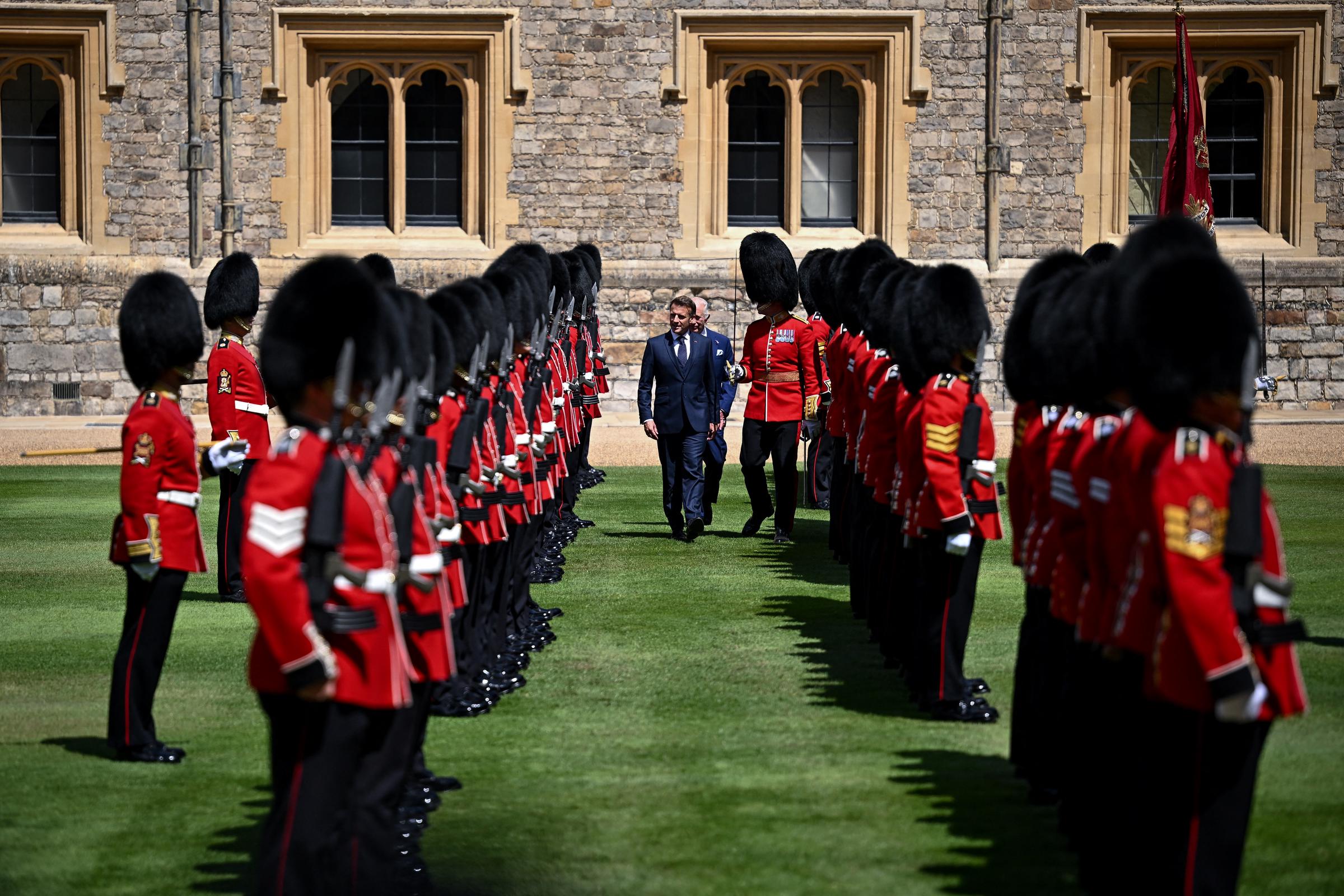 Emmanuel Macron and King Charles III review the Guard of Honor at Windsor Castle on July 8, 2025, in Windsor, England. | Source: Getty Images