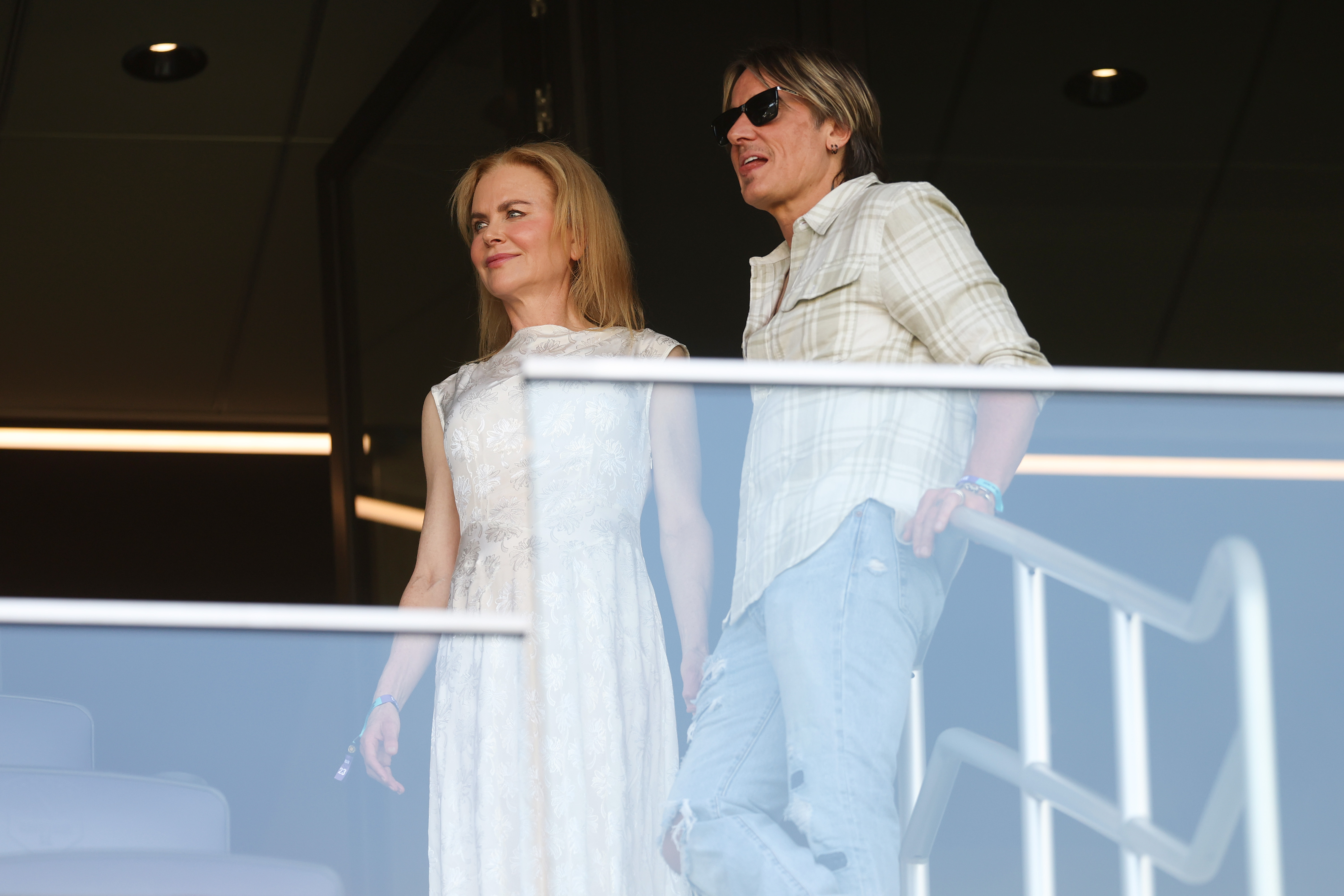 Nicole Kidman and Keith Urban watch from a VIP suite at GEODIS Park in Nashville, Tennessee, taking in the FIFA Club World Cup with composed expressions and a quiet presence above the crowd.