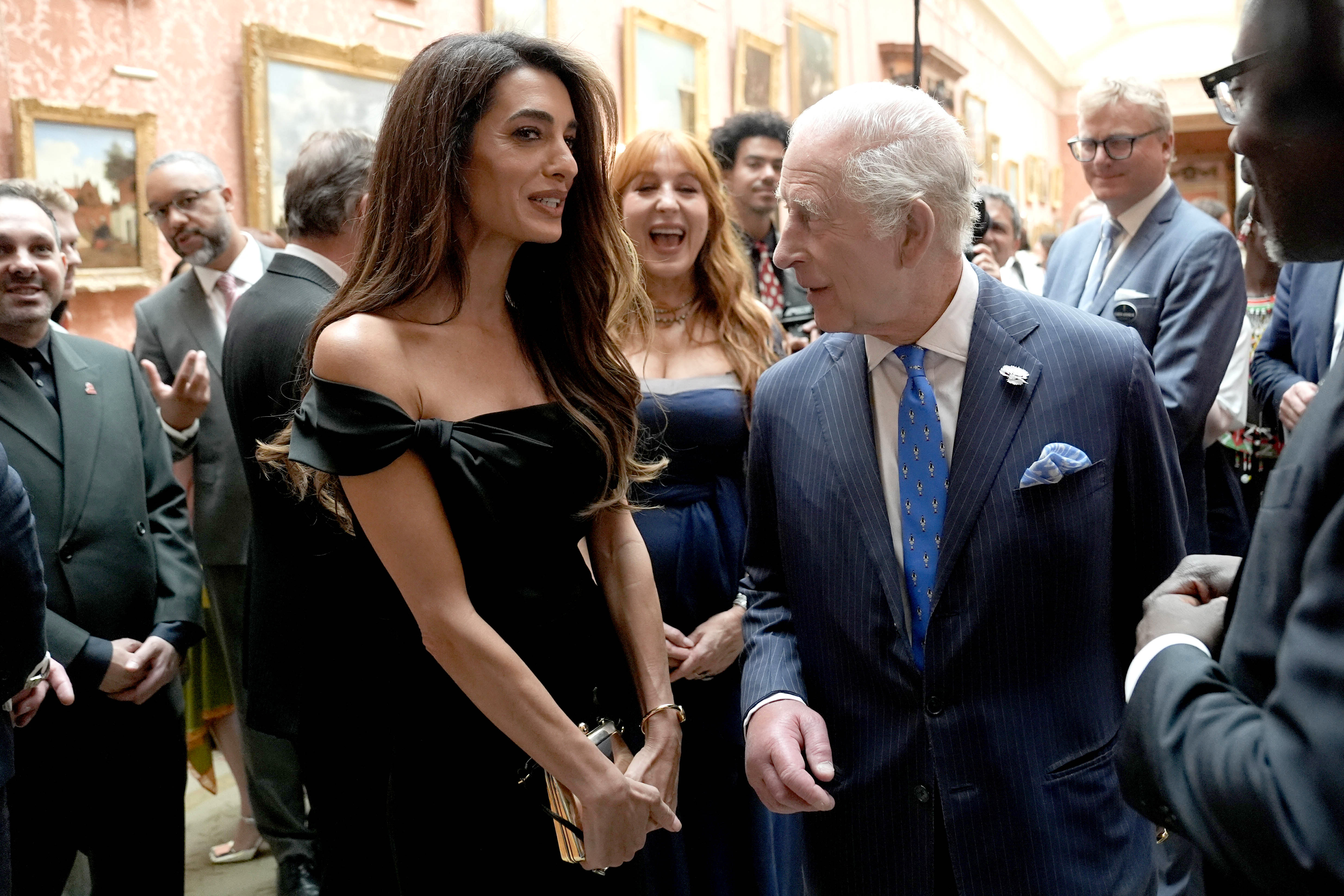 Amal Clooney speaks with King Charles III during a reception for the winners of the King's Trust Awards at in London, England | Source: Getty Images