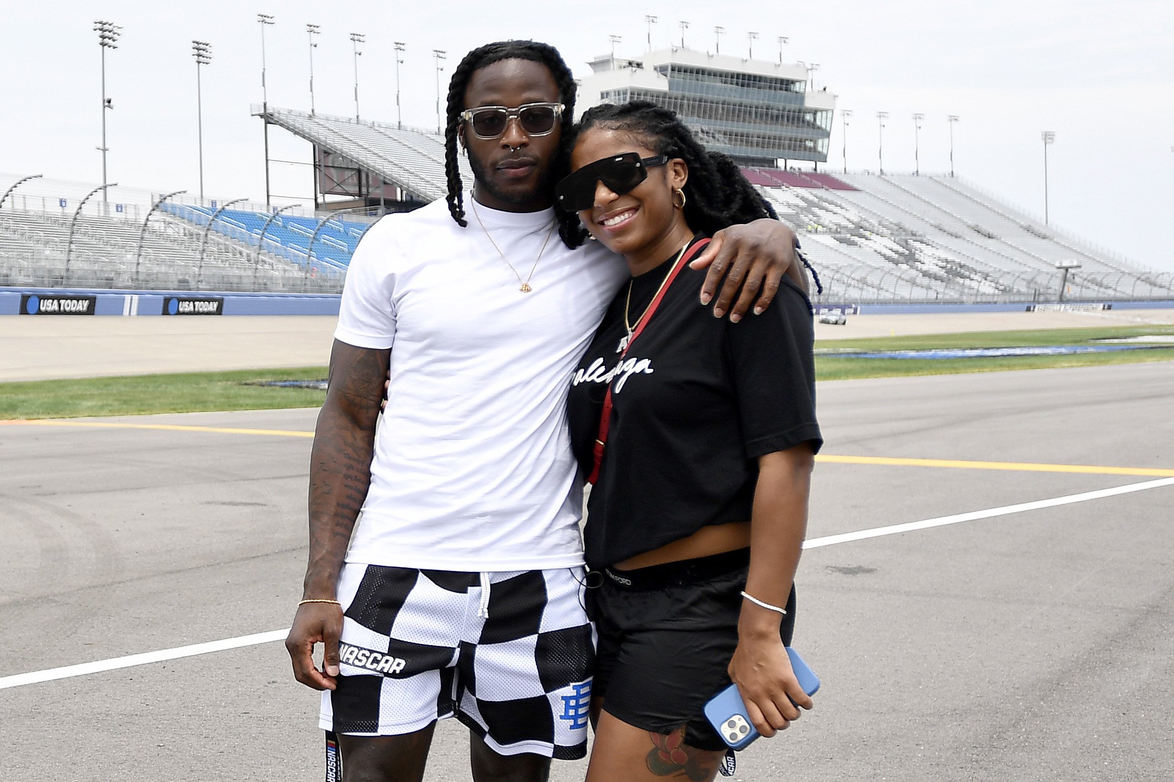 New Orleans Saints running back Alvin Kamara and WNBA player Te'a Cooper pose for photos prior to pace car practice for the NASCAR Cup Series Ally 400 at Nashville Superspeedway, on June 26, 2022, in Lebanon, Tennessee. | Source: Getty Images