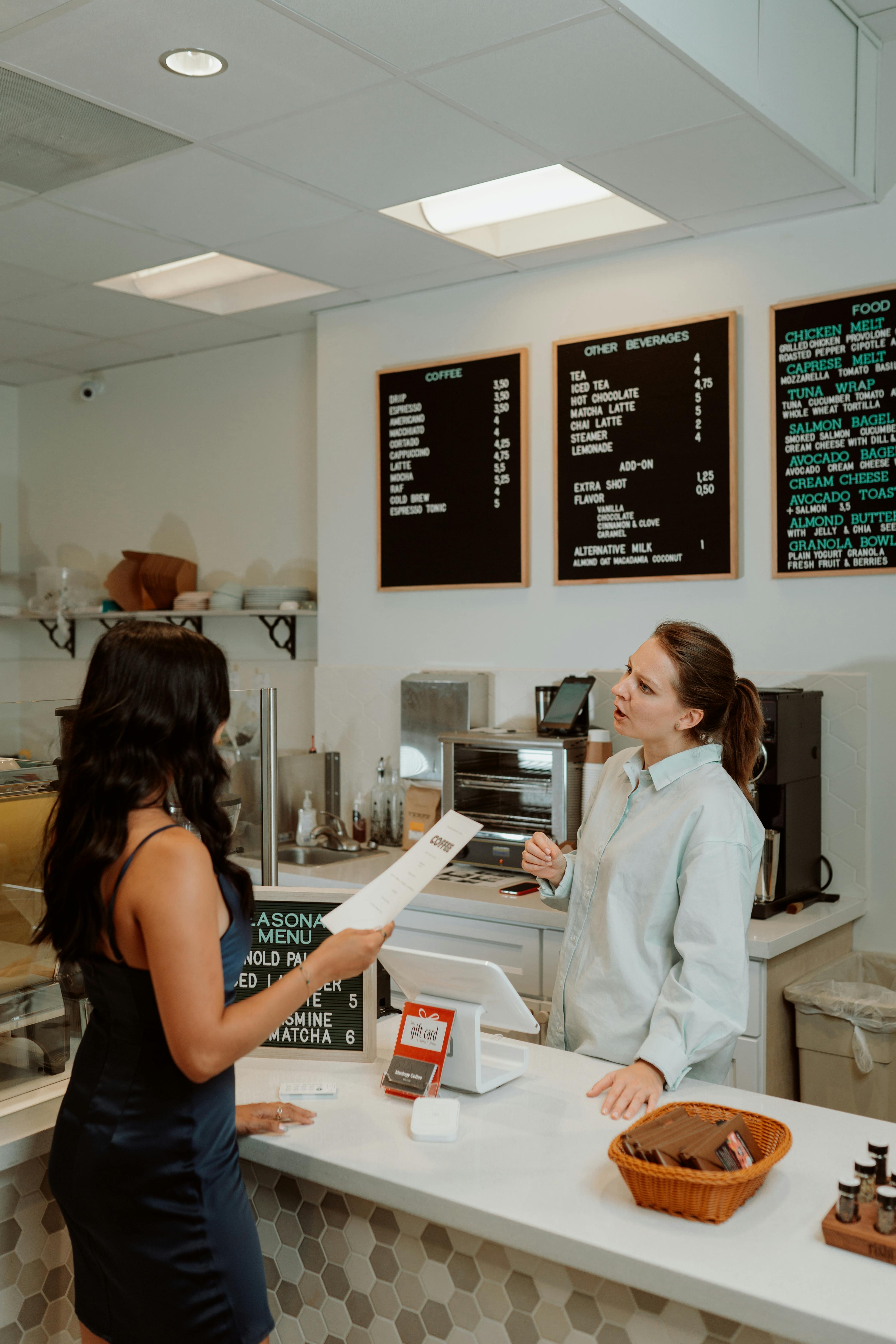 A female cashier having a conversation with a customer | Source: Pexels