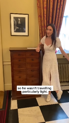 Loxton paused beside a traditional wooden chest of drawers inside No. 10, highlighting the building's classic interiors — a contrast to the modern furnishings reportedly introduced during the recent taxpayer-funded updates under Starmer's tenure. | Source: YouTube/Alice Loxton