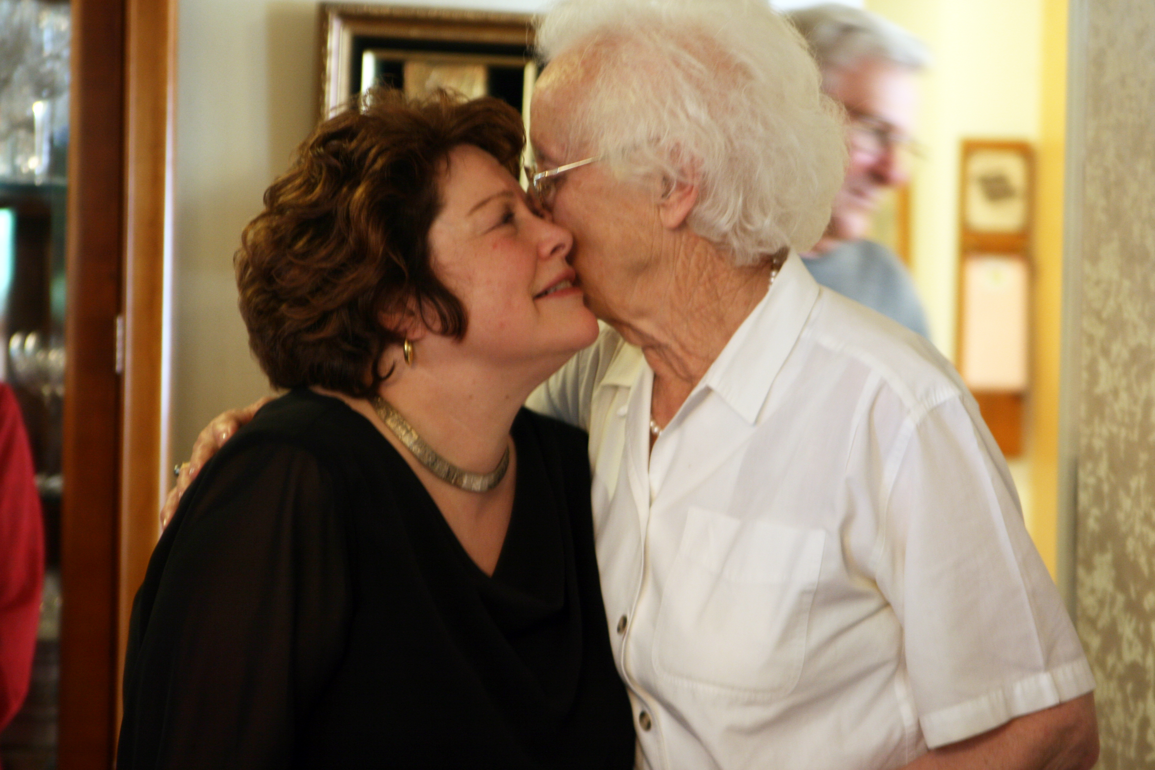 A woman lovingly embracing her mother-in-law | Source: Flickr