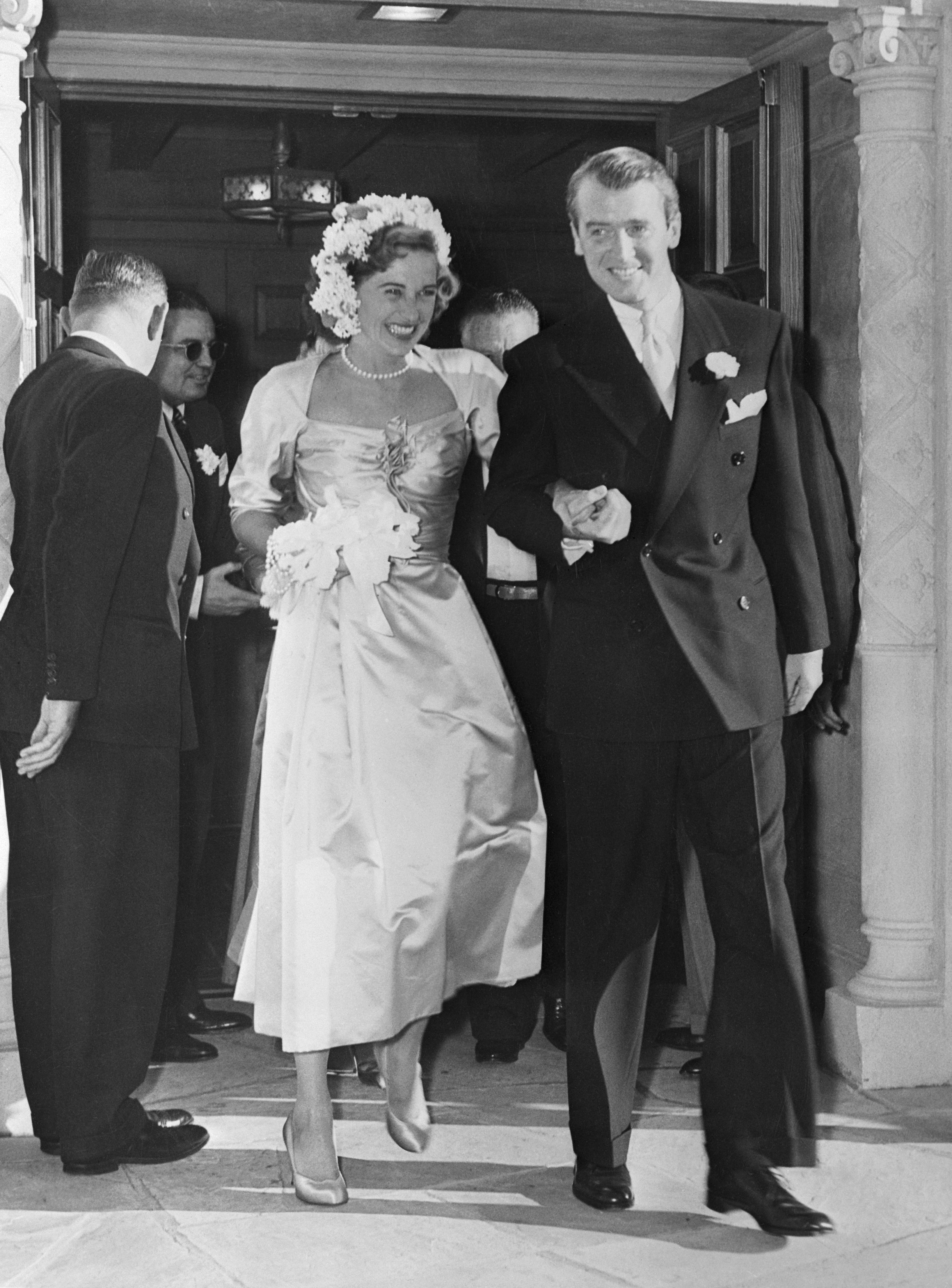 Gloria Hatrick McLean and Jimmy Stewart after getting married at the Brentwood Presbyterian Church, in Brentwood, California, on August 9, 1949. | Source: Bettmann/Getty Images
