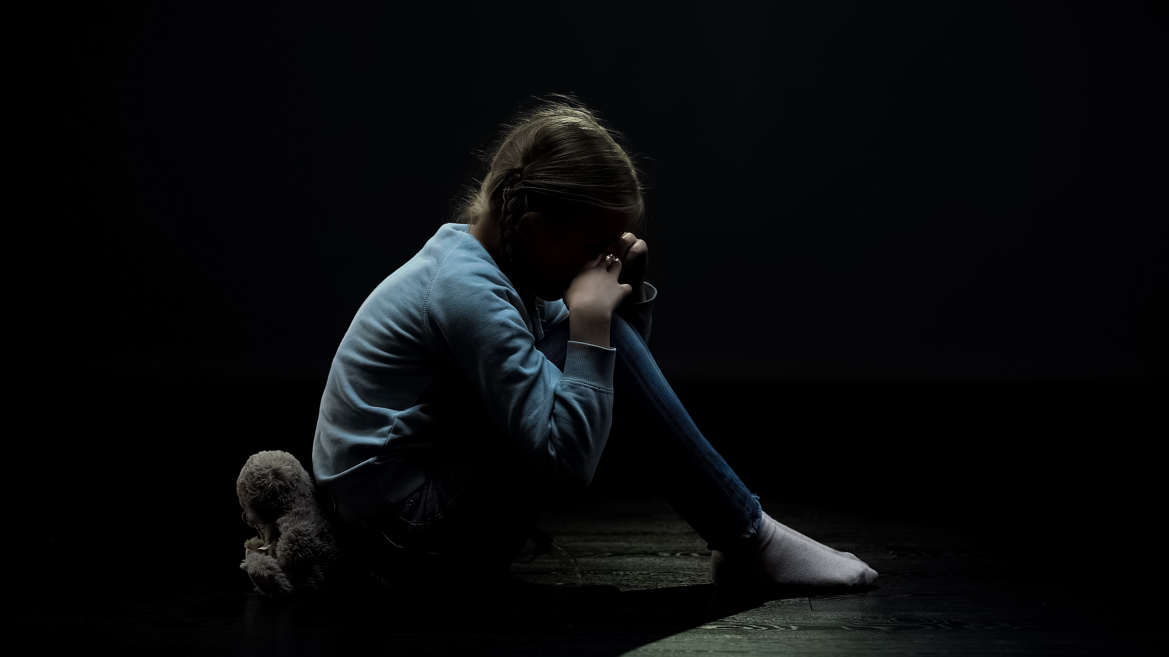 Sad girl child in basement | Source: Shutterstock.com