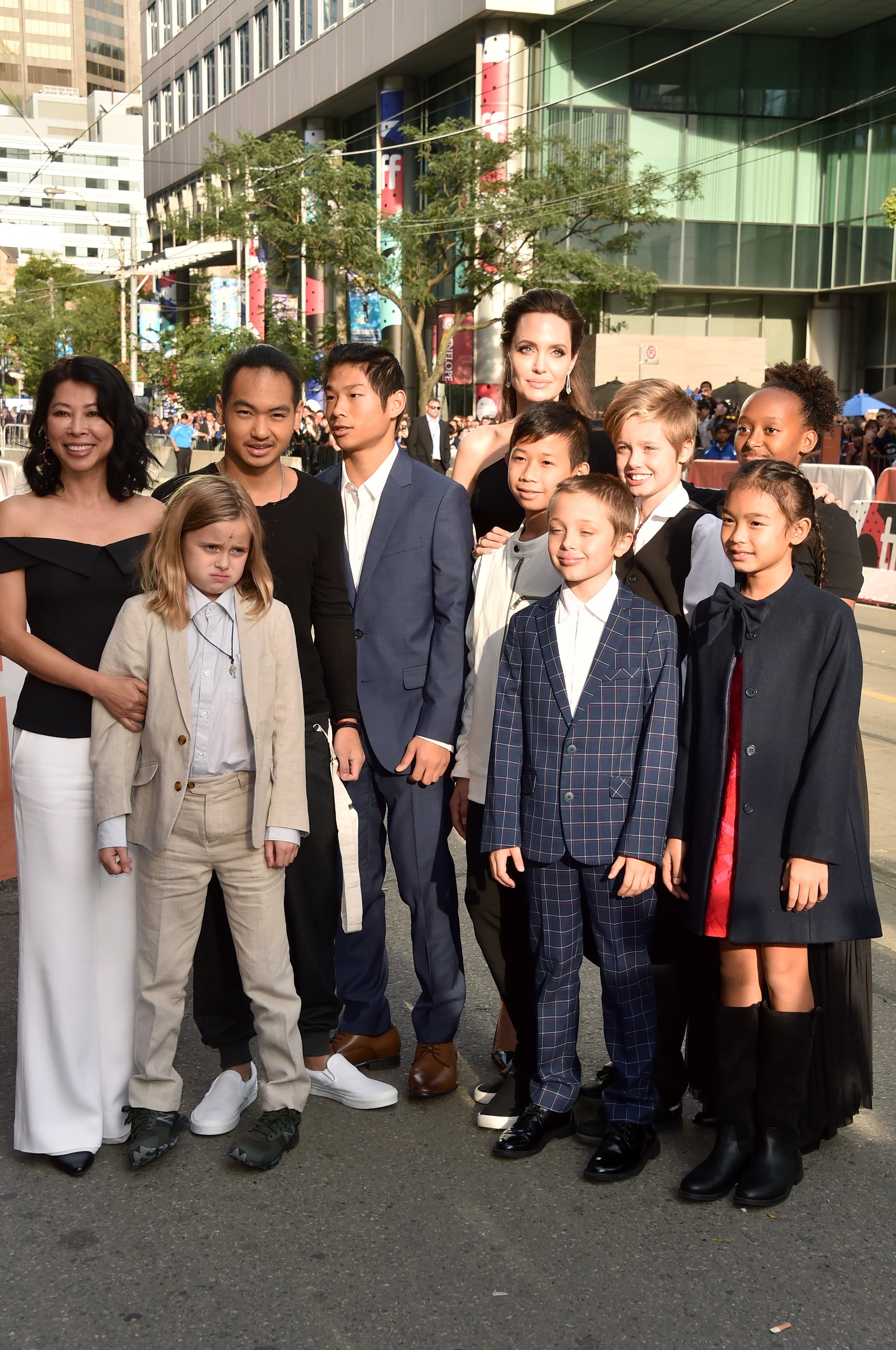 Loung Ung, Vivienne Jolie-Pitt, Maddox Jolie-Pitt, Pax Jolie-Pitt, Angelina Jolie, Kimhak Mun, Knox Jolie-Pitt, Shiloh Jolie-Pitt, Zahara Jolie-Pitt and Sareum Srey Moch attend the "First They Killed My Father" premiere during the 2017 Toronto International Film Festival at Princess of Wales Theatre on September 11, 2017 in Toronto, Canada. | Source: Getty Images