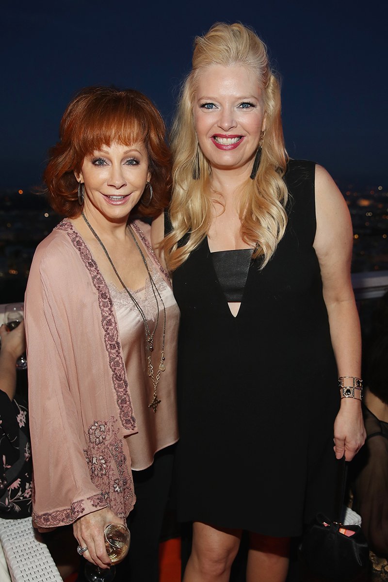 Reba McEntire and Melissa Peterman attend the Rooftop Dinner at the Waldorf Astoria Hotel Cavalieri, Benefiting The Andrea Bocelli Foundation and the Muhammad Ali Parkinson Center on September 6, 2017 in Rome, Italy | Photo: Getty Image