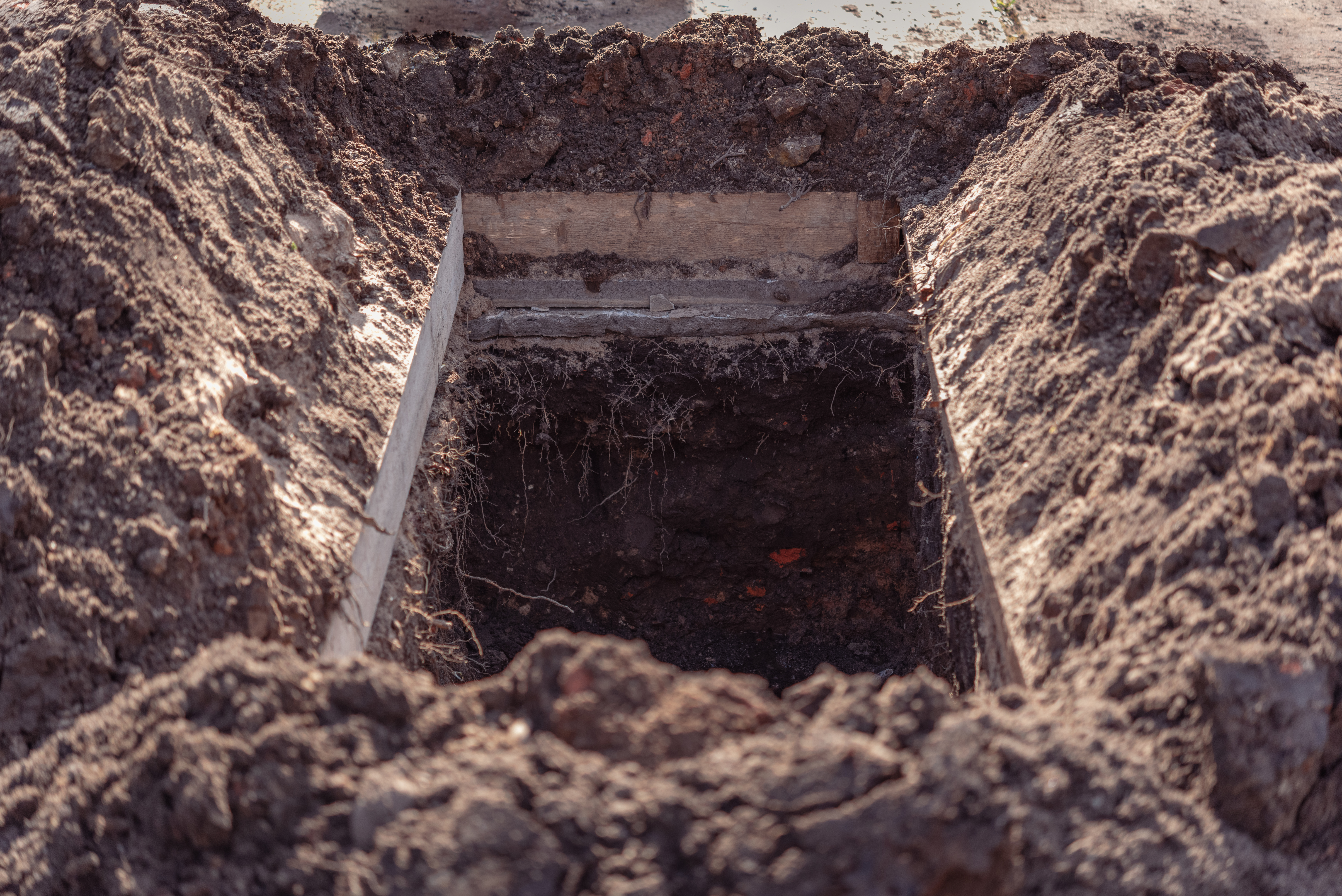 A grave dug out in a cemetery | Source: Shutterstock