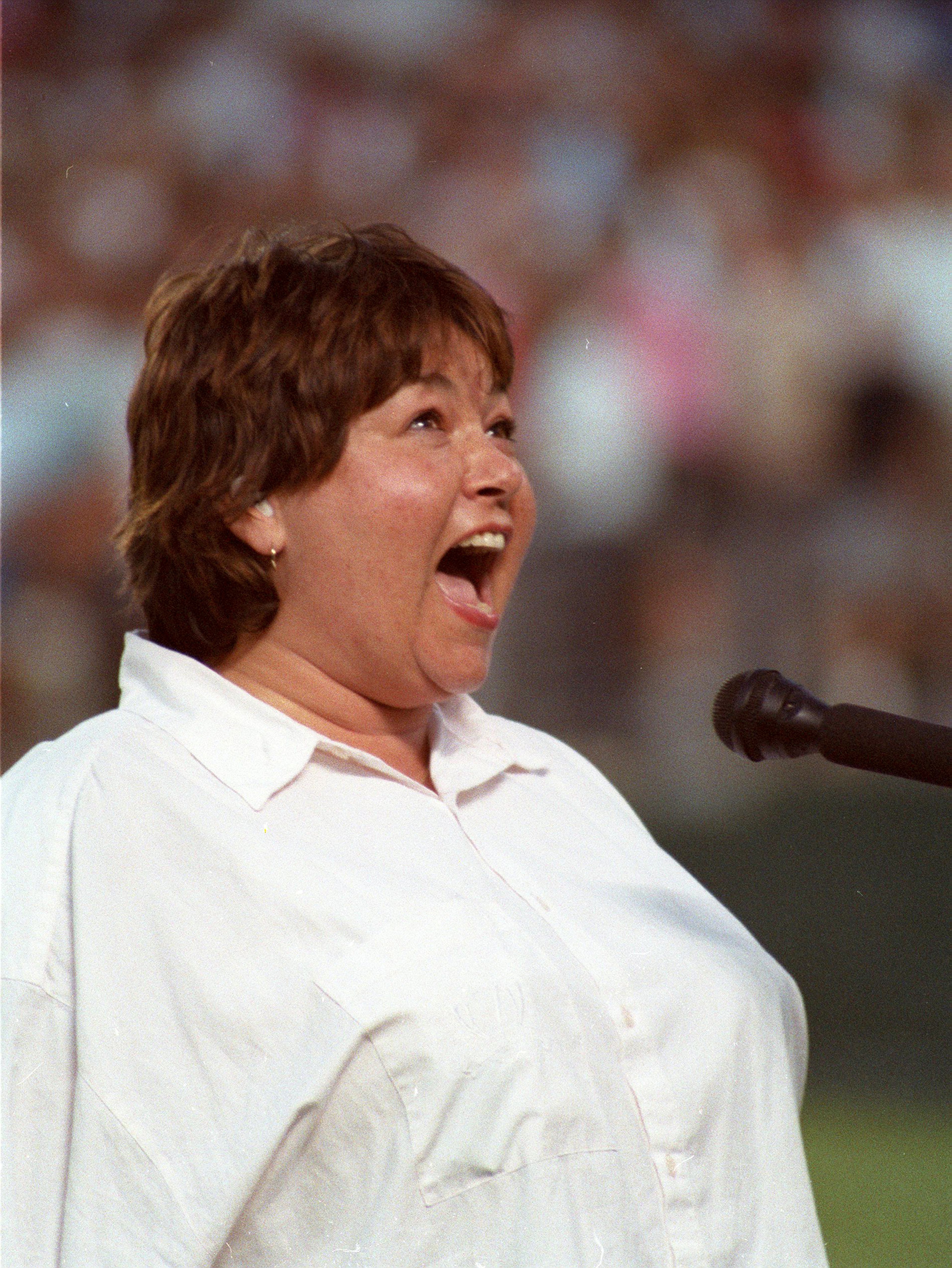 For some people, her rendition felt like burning the flag. In this photo, American actress and comedian Roseanne Barr performed "The Star-Spangled Banner" at Jack Murphy Stadium on July 25, 1990, in San Diego, California. | Source: Getty Images