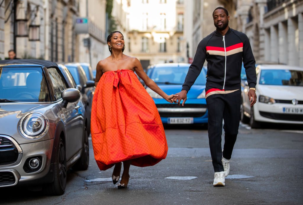 Gabrielle Union walks hand in hand with her husband Dwyane Wade during Paris Fashion Week on January 19, 2020, in Paris, France | Source: Christian Vierig/Getty Images