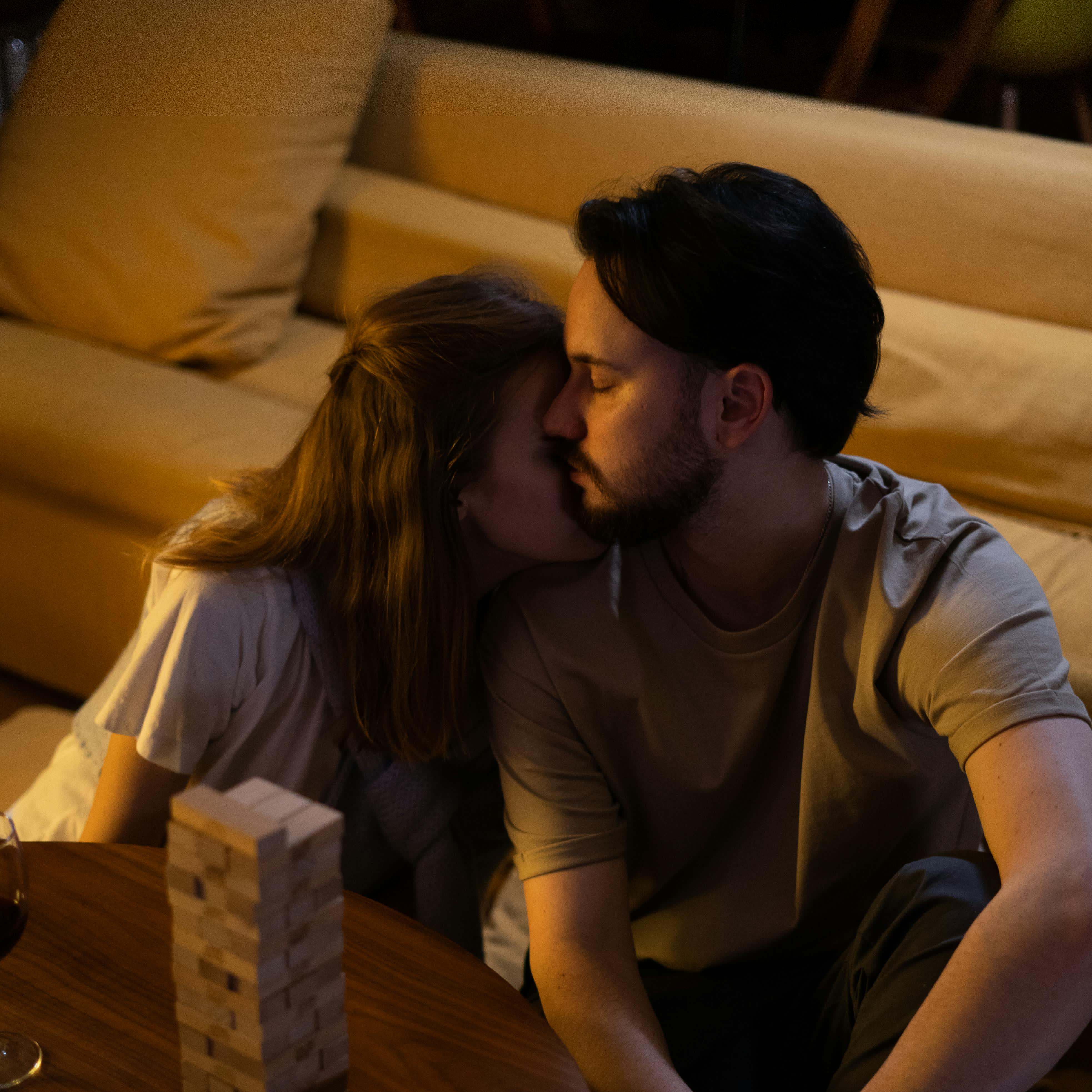 A couple share a reflective moment, sitting on a living room floor | Source: Pexels