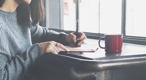 A woman writing. | Source: Shutterstock.
