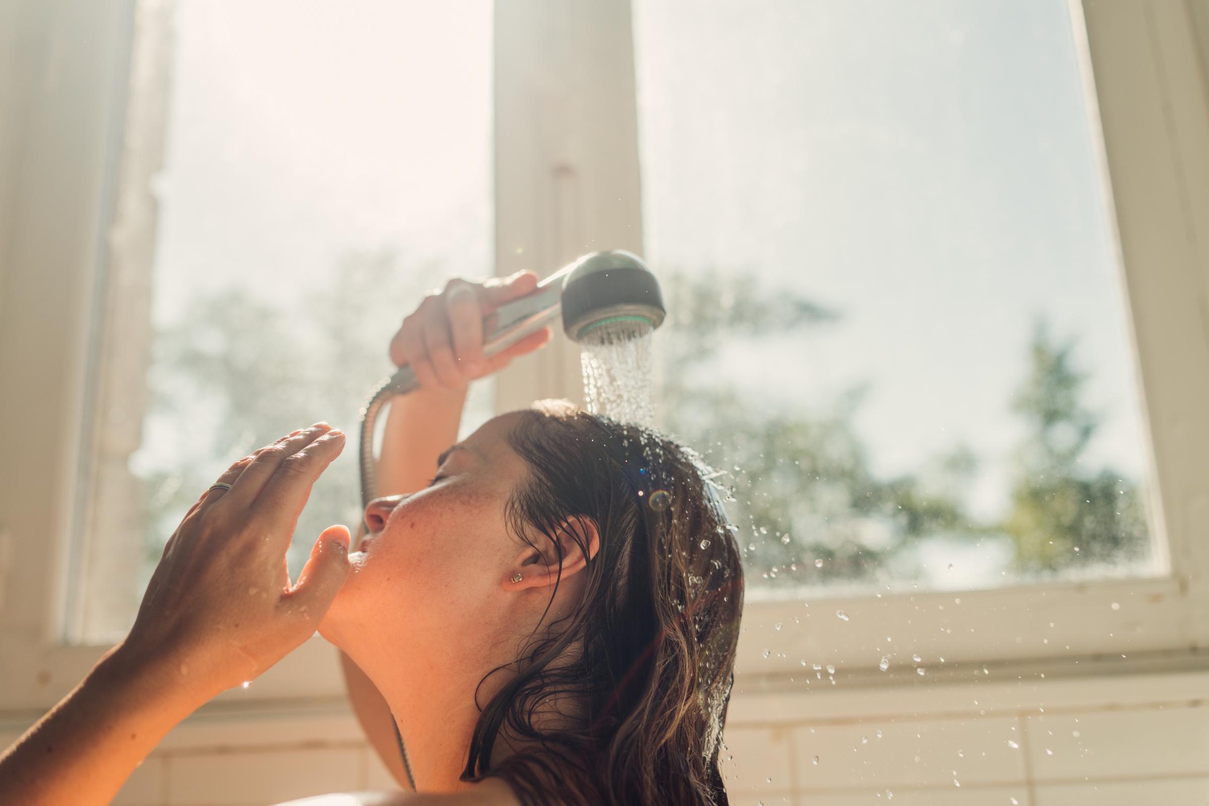 A woman taking a warm shower | Source: Getty Images