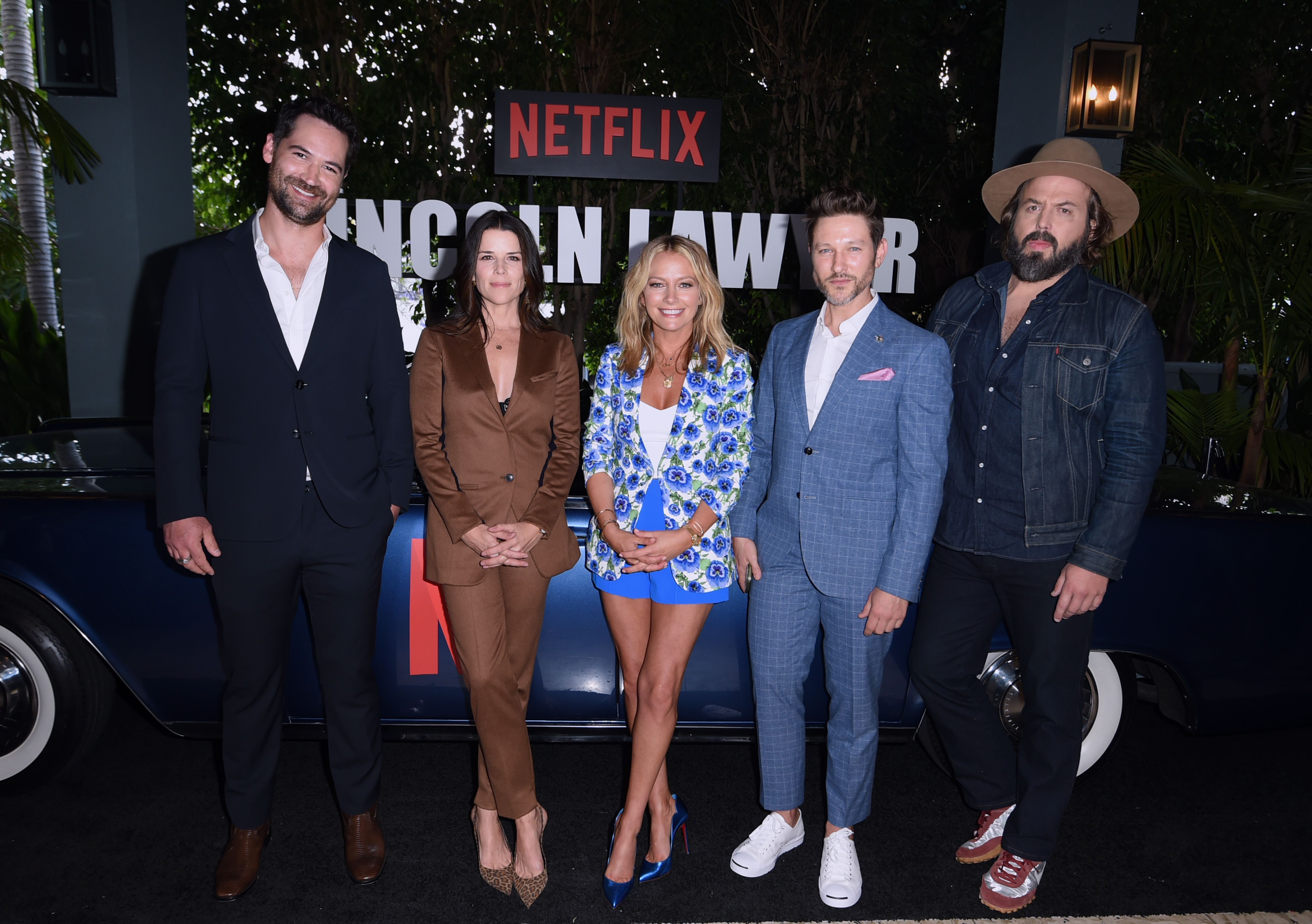 "The Lincoln Lawyer" cast members Manuel García-Rulfo (far left), Neve Campbell (second to left), Becki Newton (center), Michael Graziadei (second to right), and Angus Sampson (far right) at the Netflix series' special screening at The London in West Hollywood, California on May 09, 2022. | Source: Getty Images