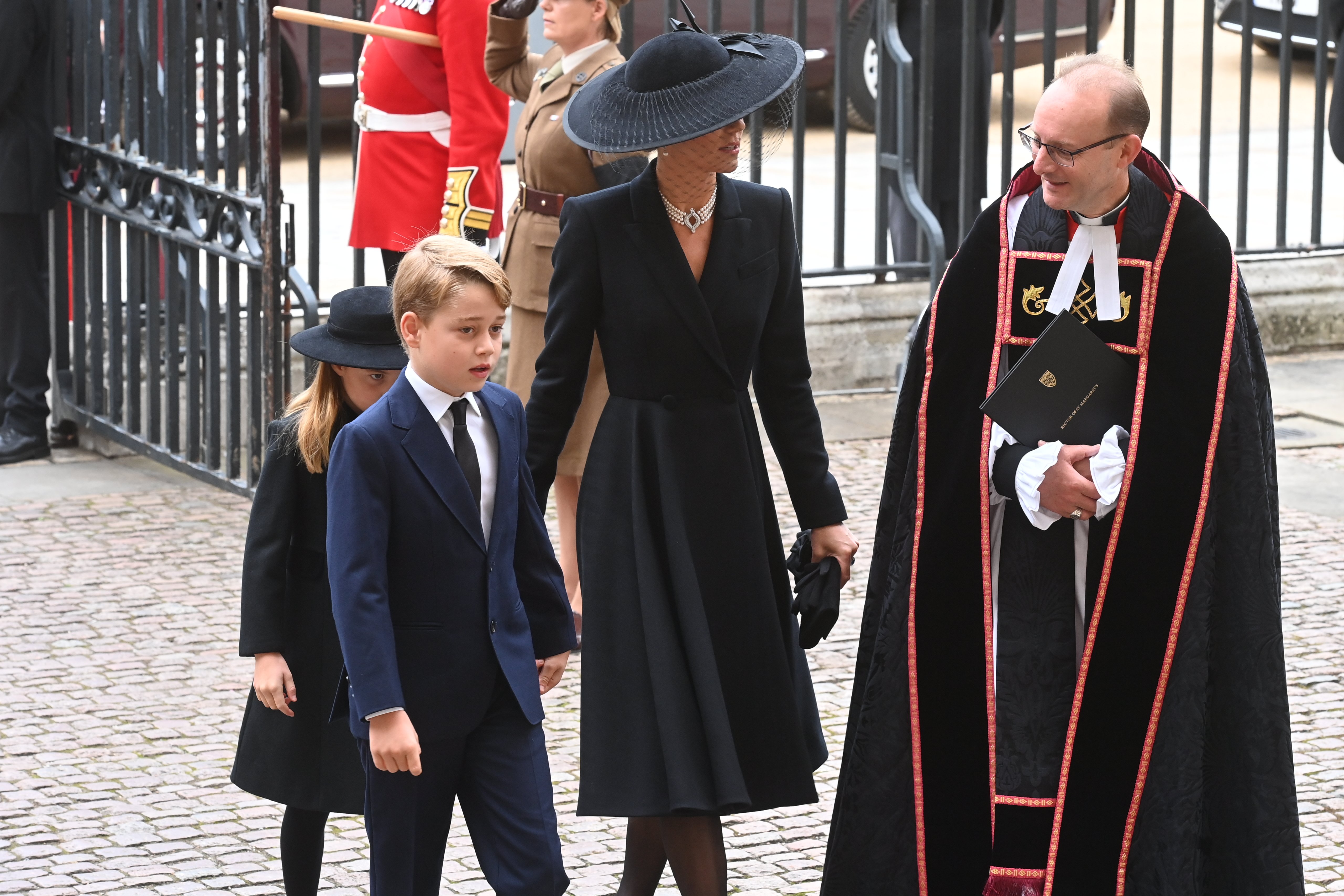Princess Charlotte Prince George and Catherine, walk behind The Queen's funeral cortege as it proceeds towards Westminster Abbey on September 19, 2022, in London, England. | Source: Getty Images