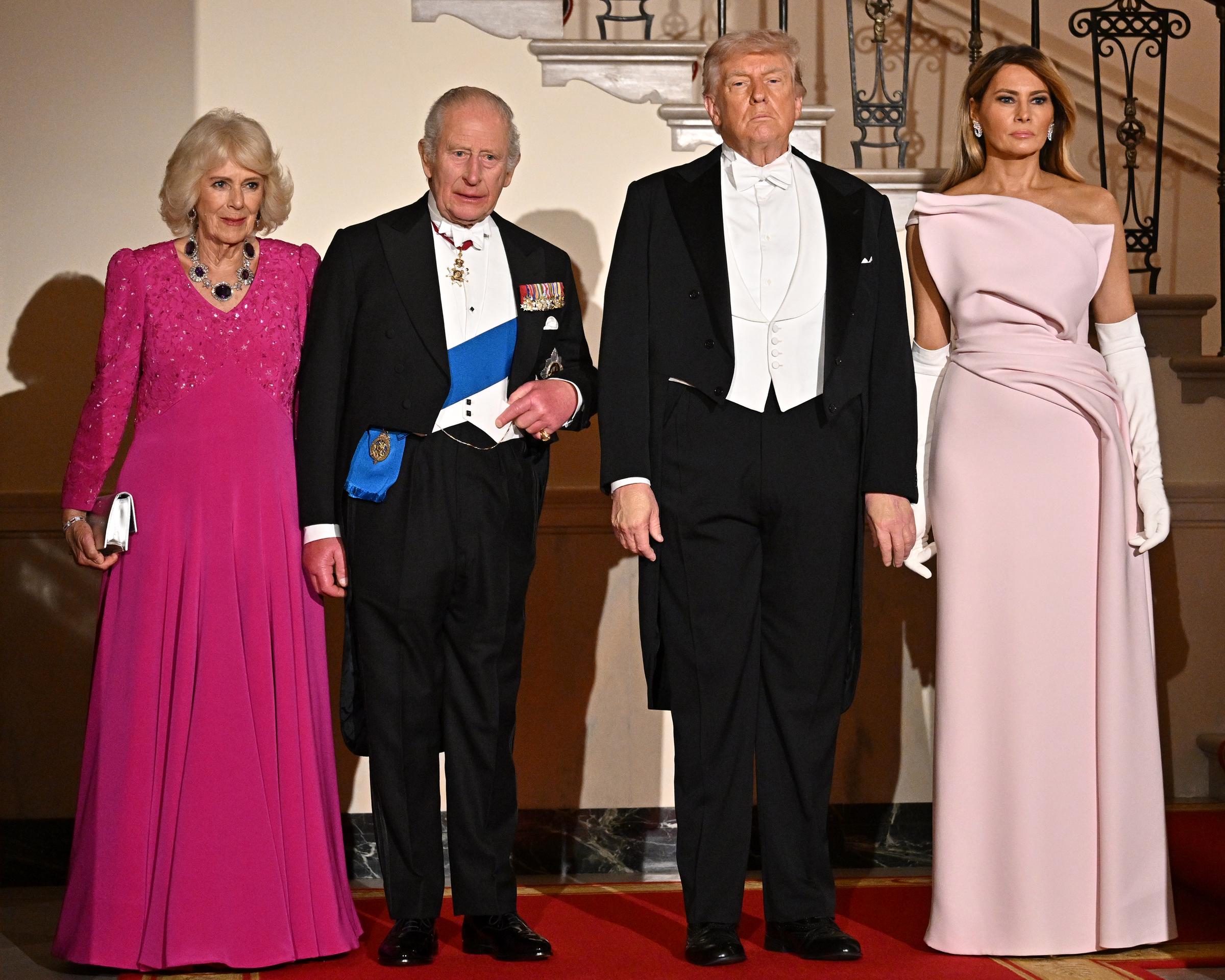Queen Camilla, King Charles III, U.S. President Donald Trump, and First Lady Melania Trump pose on Grand Staircase during an official state dinner hosted by the President and First Lady at The White House on day two of the State Visit of King Charles III and Queen Camilla to the United States of America, on 28 April 2026 in Washington, DC. | Source: Getty Images
