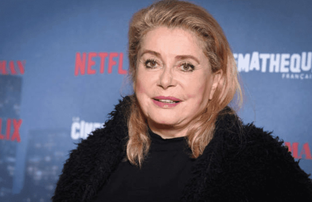 Catherine Deneuve poses on the red carpet at the  premiere for "The Irishman," on October 17, 2019 in Paris, France | Source: Stephane Cardinale - Corbis/Corbis via Getty Images