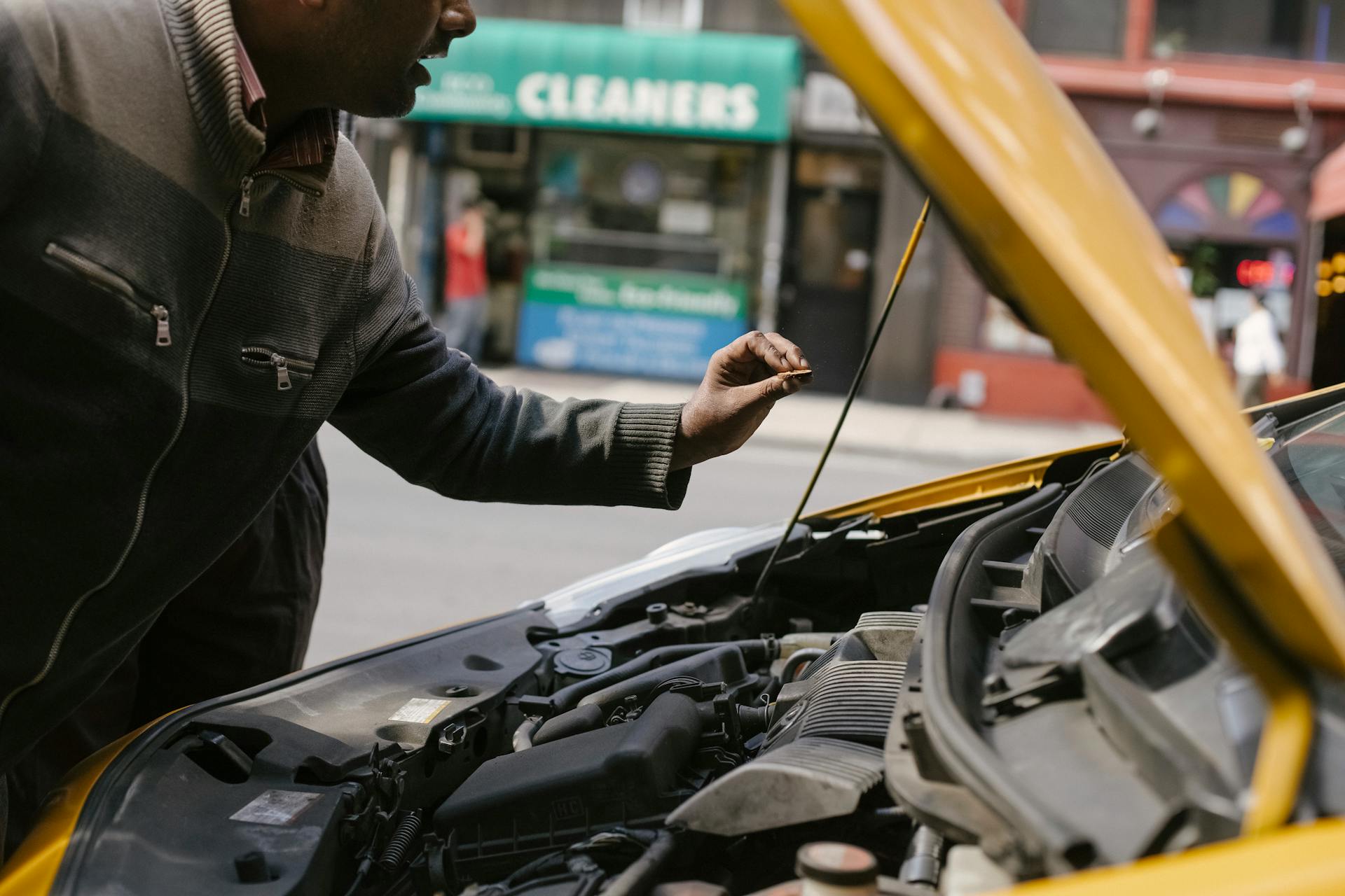 A man peering at a car engine | Source: Pexels