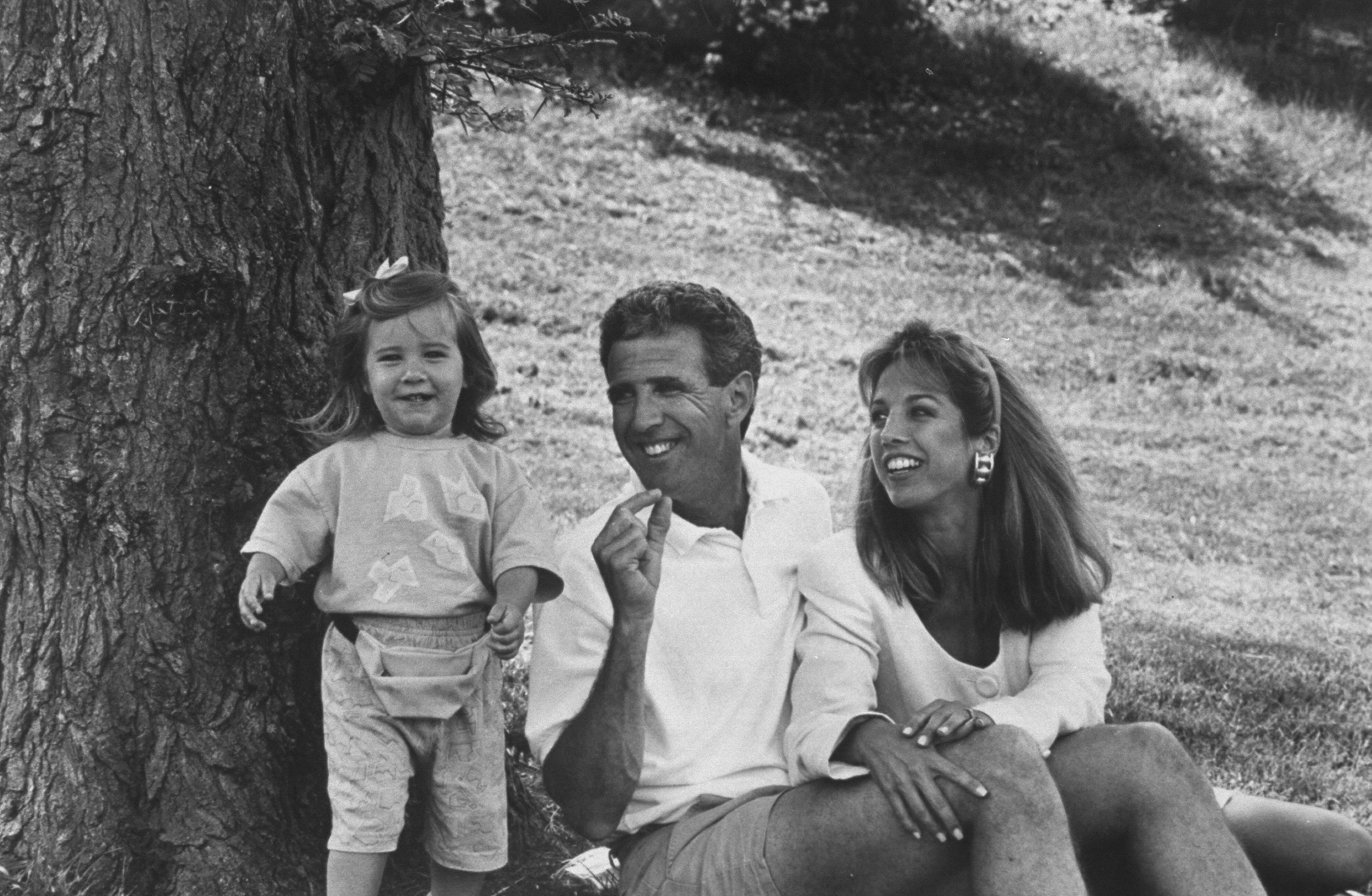 Denise Austin and Jeff Austin are pictured with their 21-month-old daughter, Kelly, sitting under a tree in a park near their home, on June 3, 1992 | Source: Source: Getty Images