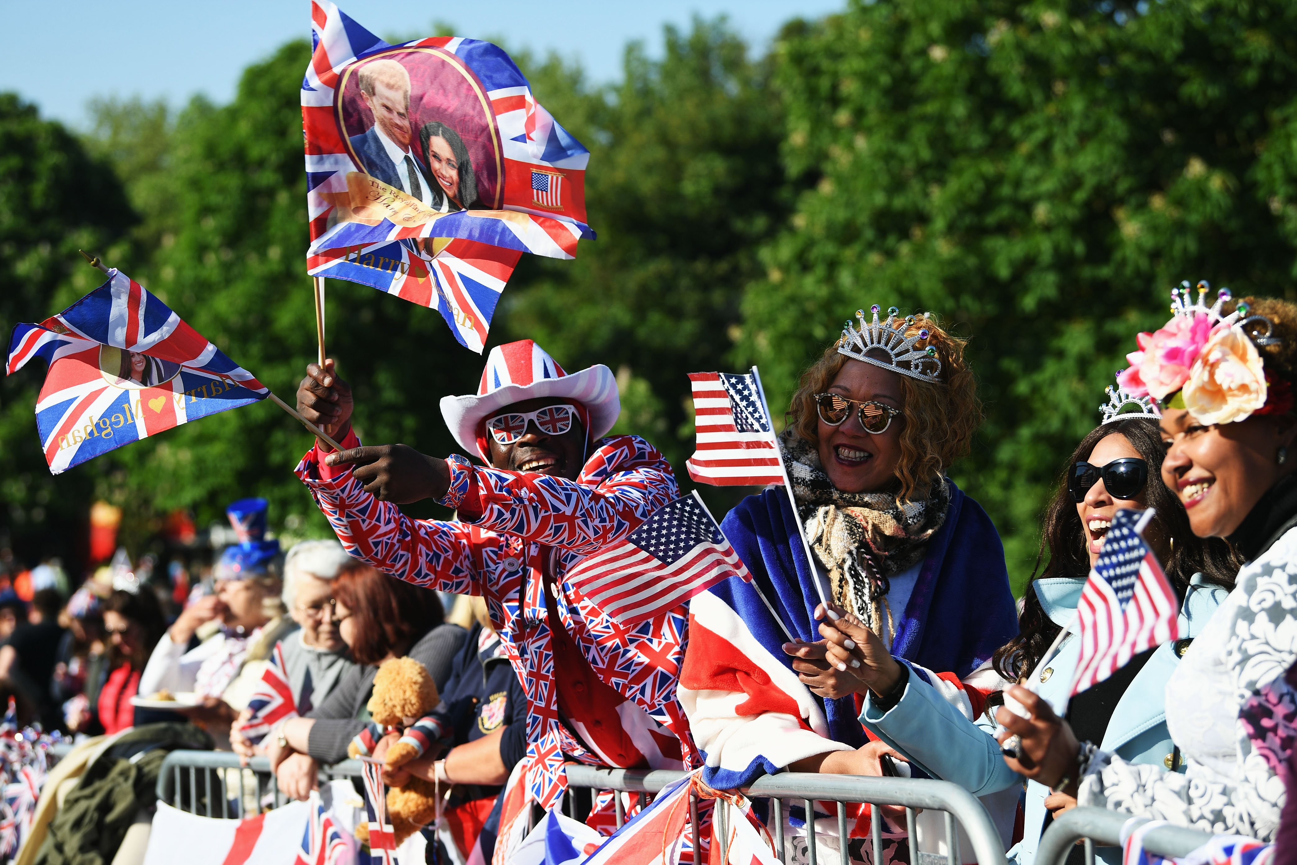 Royal fans celebrating during the wedding of Prince Harry and Meghan Markle on May 19, 2018 in Windsor, England. | Source: Getty Images 