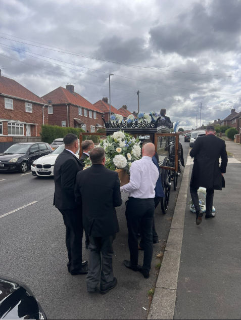 Mourners carrying a coffin with David's body inside from a post dated August 27, 2025 | Source: Facebook/rosefuneralsmemorials