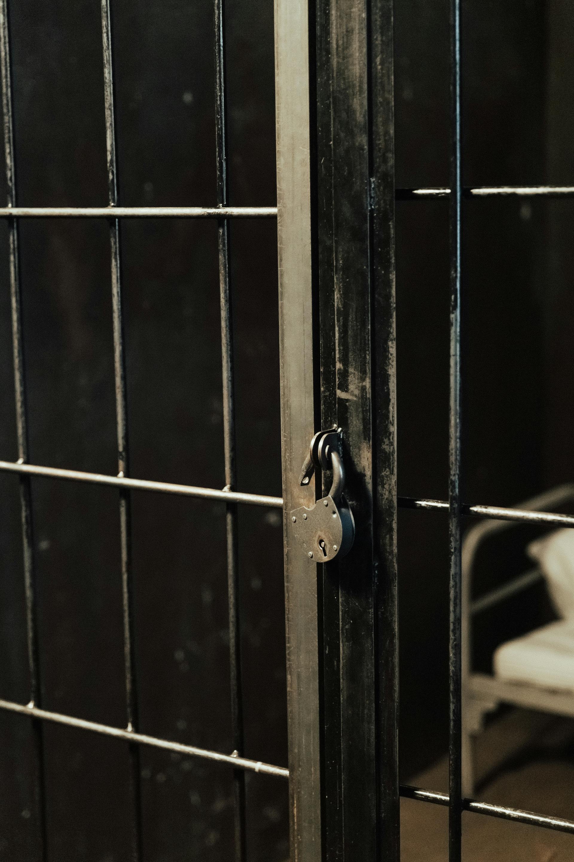 Jail bars closed with a padlock | Source: Pexels