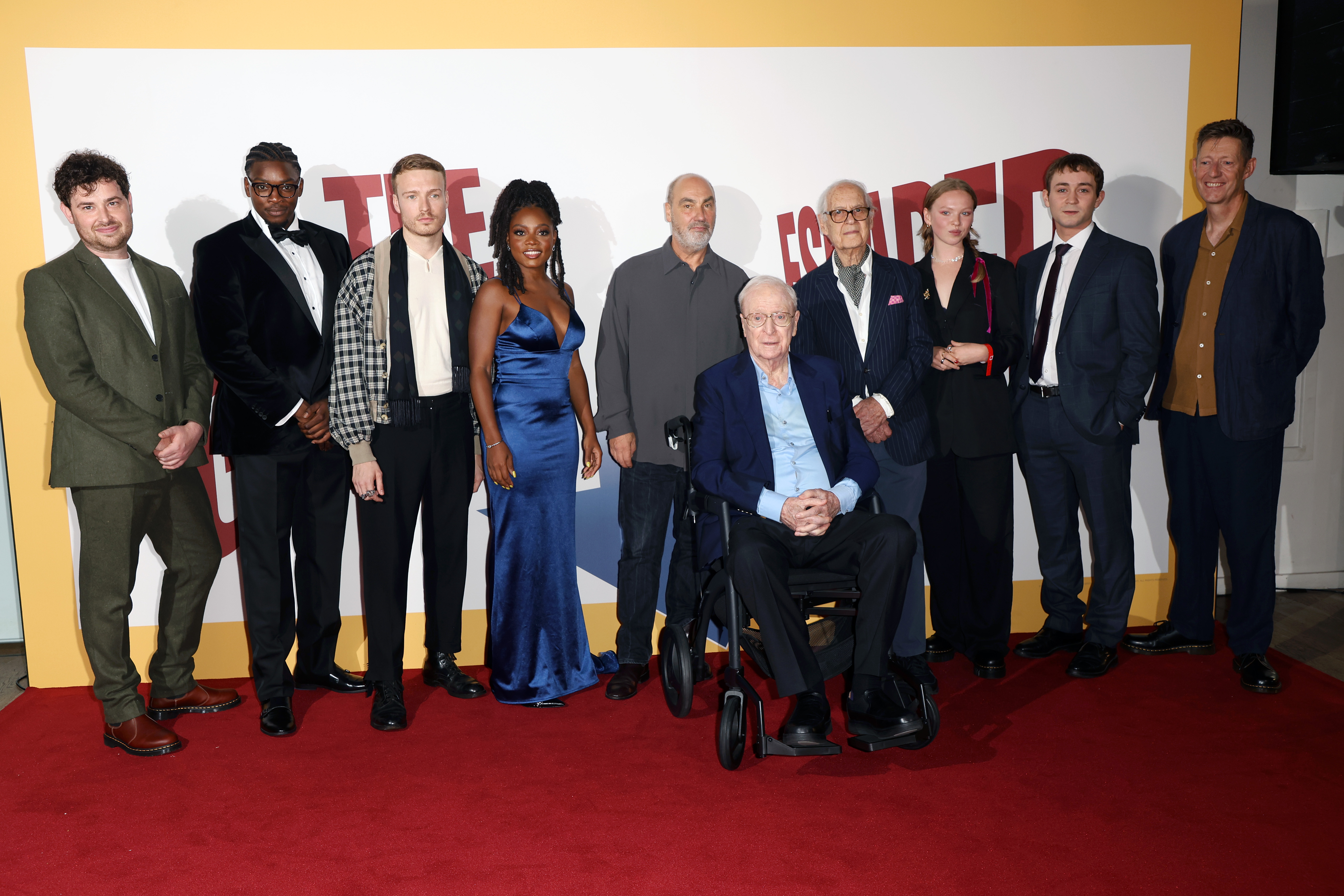 (L-R) Brennan Reece, Victor Oshin, Will Fletcher, Danielle Vitalis, Oliver Parker, Sir Michael Caine, John Standing, Laura Marcus, Elliot Norman and William Ivory at the world premiere of "The Great Escaper," September 2023 | Source: Getty Images