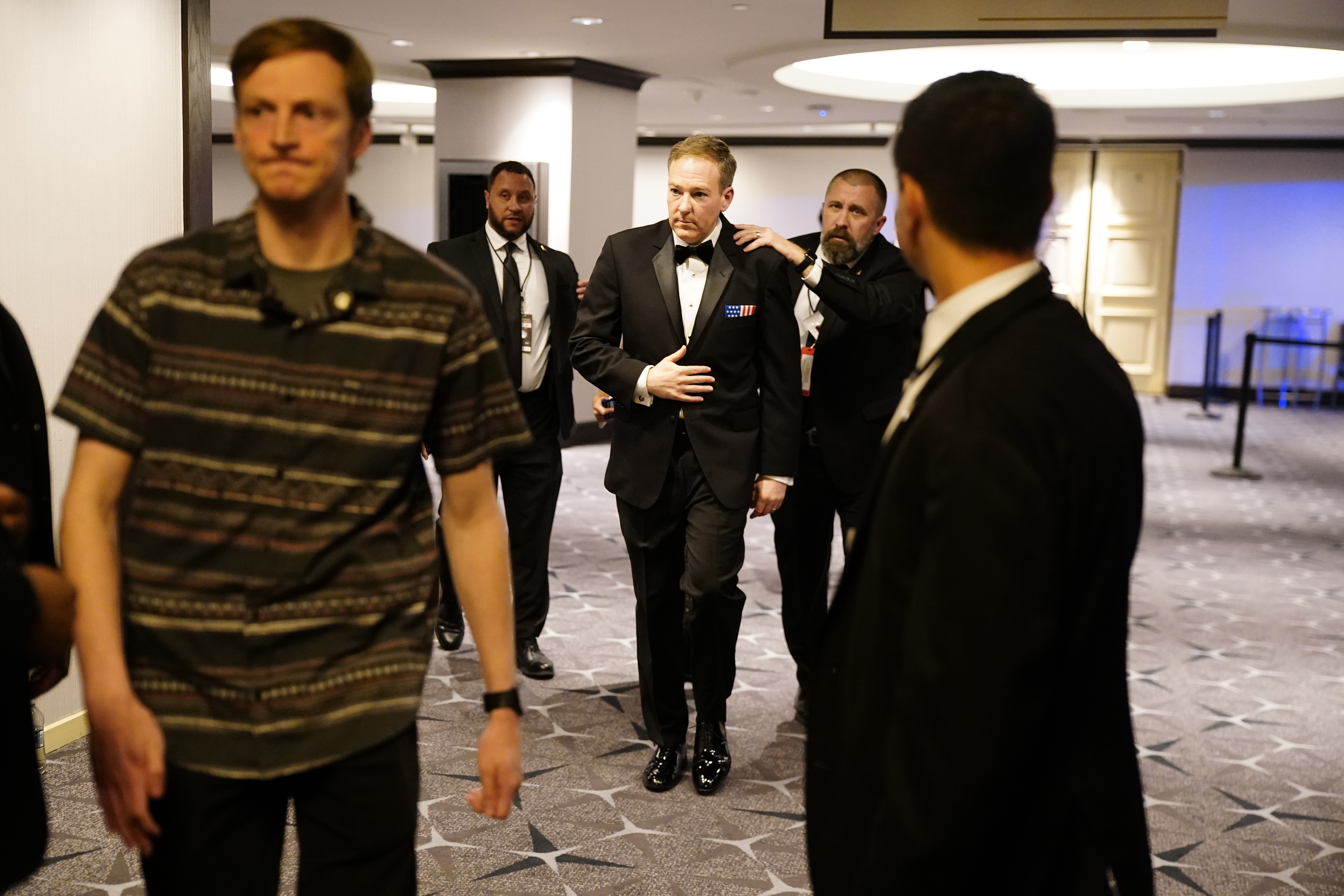 Agents escort people out of the Washington Hilton after the gn fire incident on April 25, 2026 | Source: Getty Images