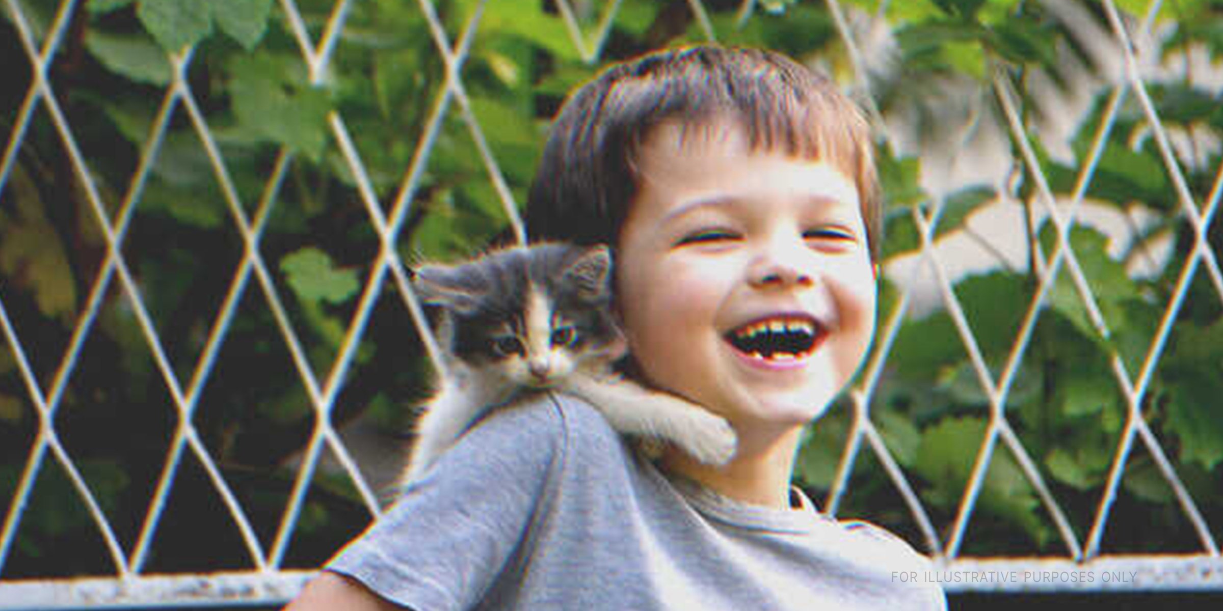 Smiling Boy With Kitten | Source: Shutterstock