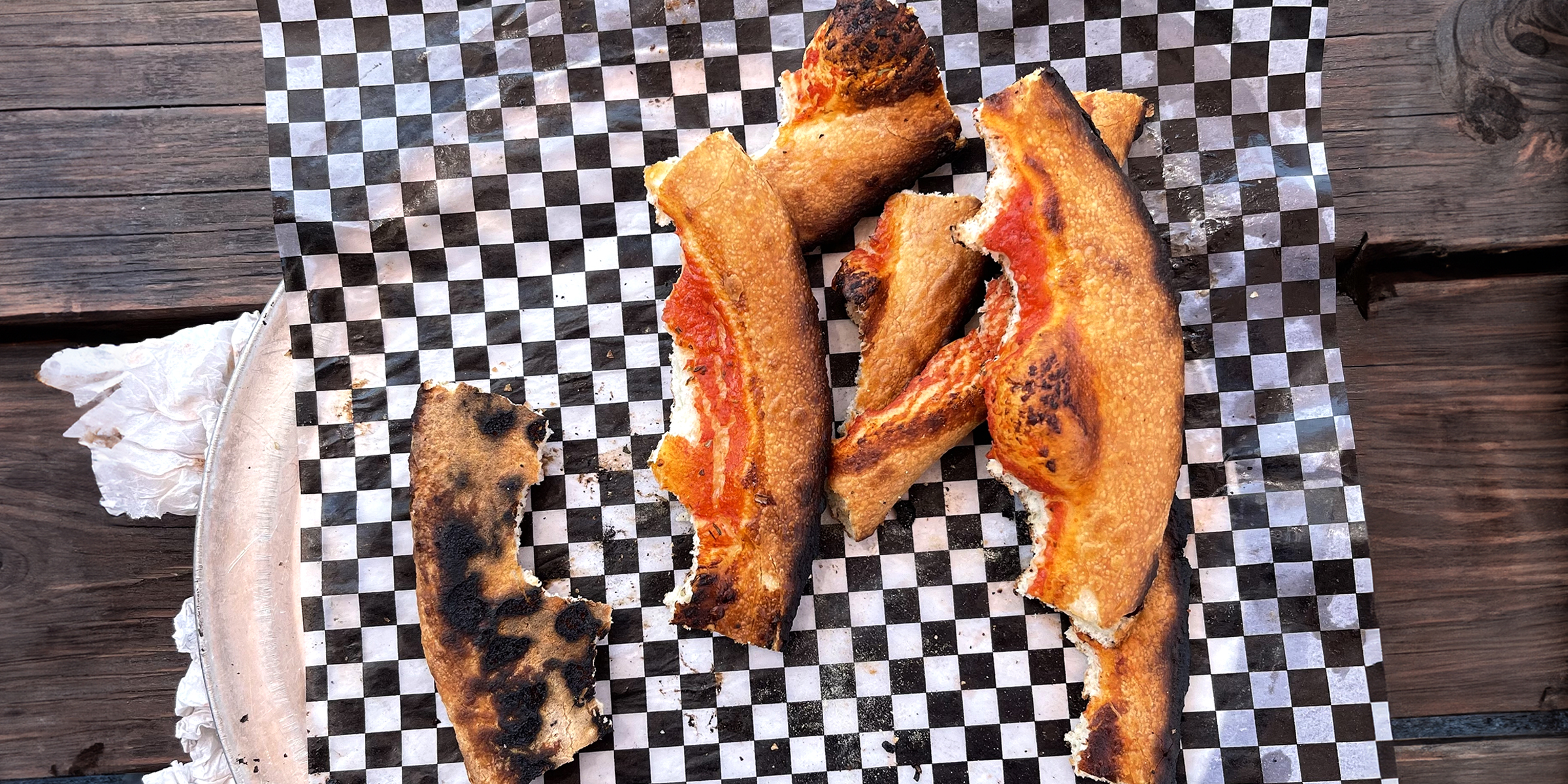 A bunch of burnt pizza crusts | Source: Flickr.com/sarahstierch/CC BY 2.0