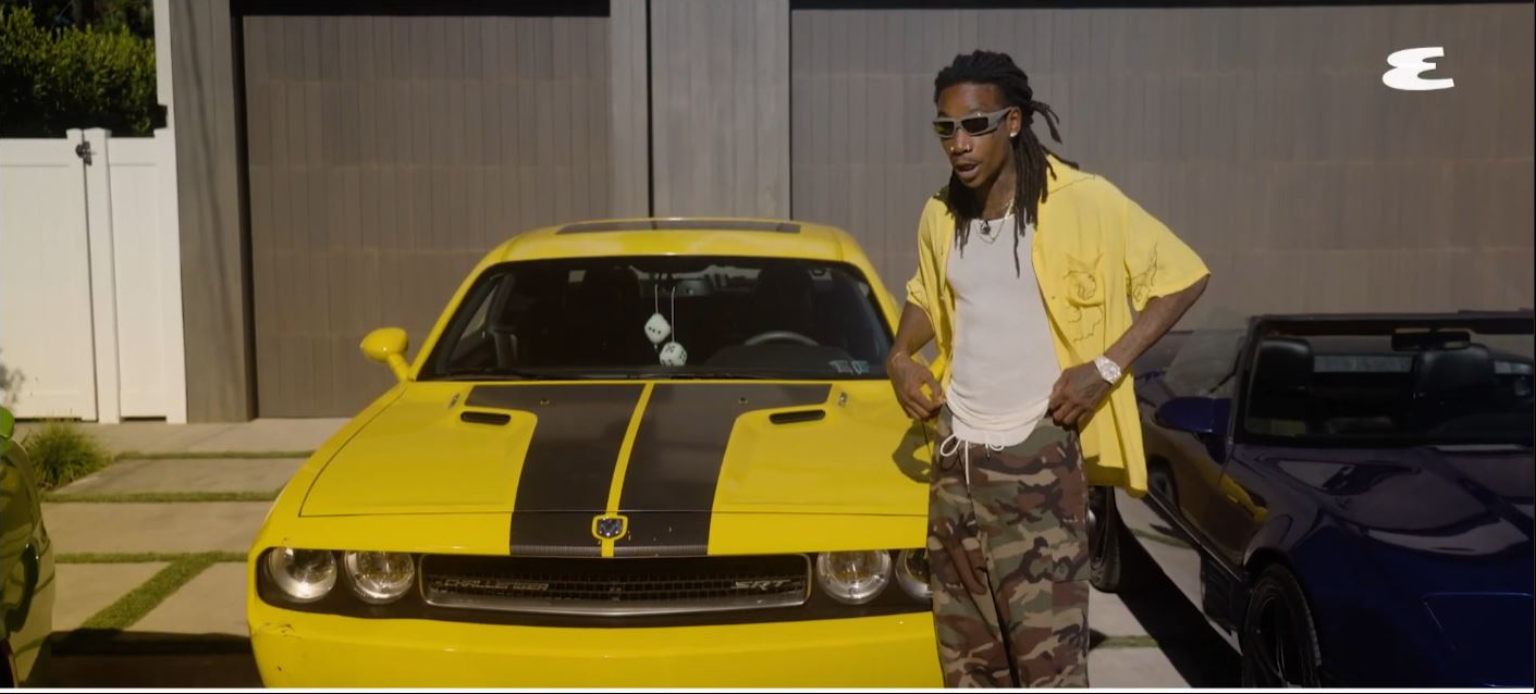 Wiz Khalifa poses beside his Dodge Challenger SRT8 while recalling the memories and success that followed the muscle car's connection to his first No. 1 hit. | Source: YouTube/Esquire