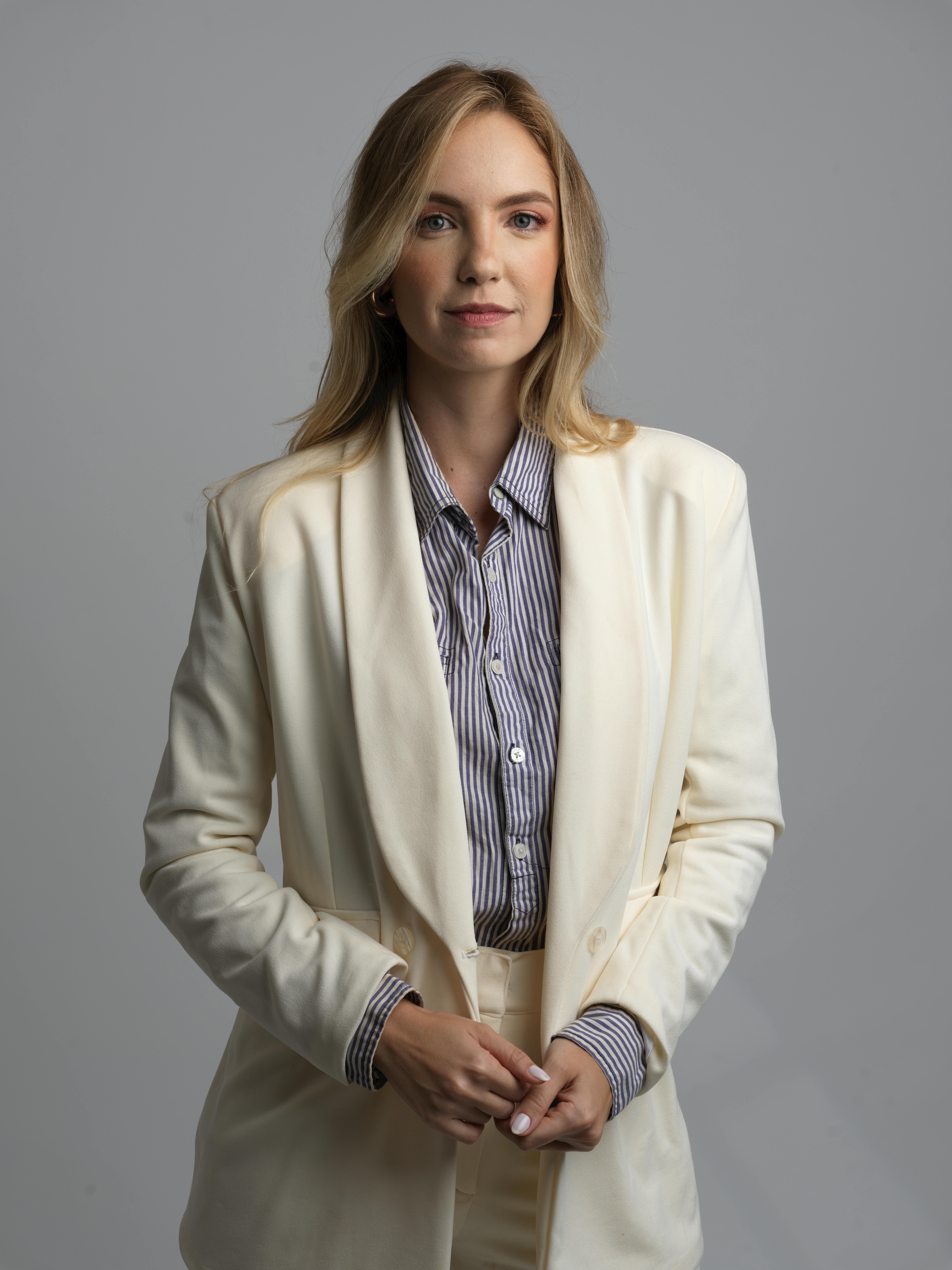 A happy woman in a suit | Source: Pexels