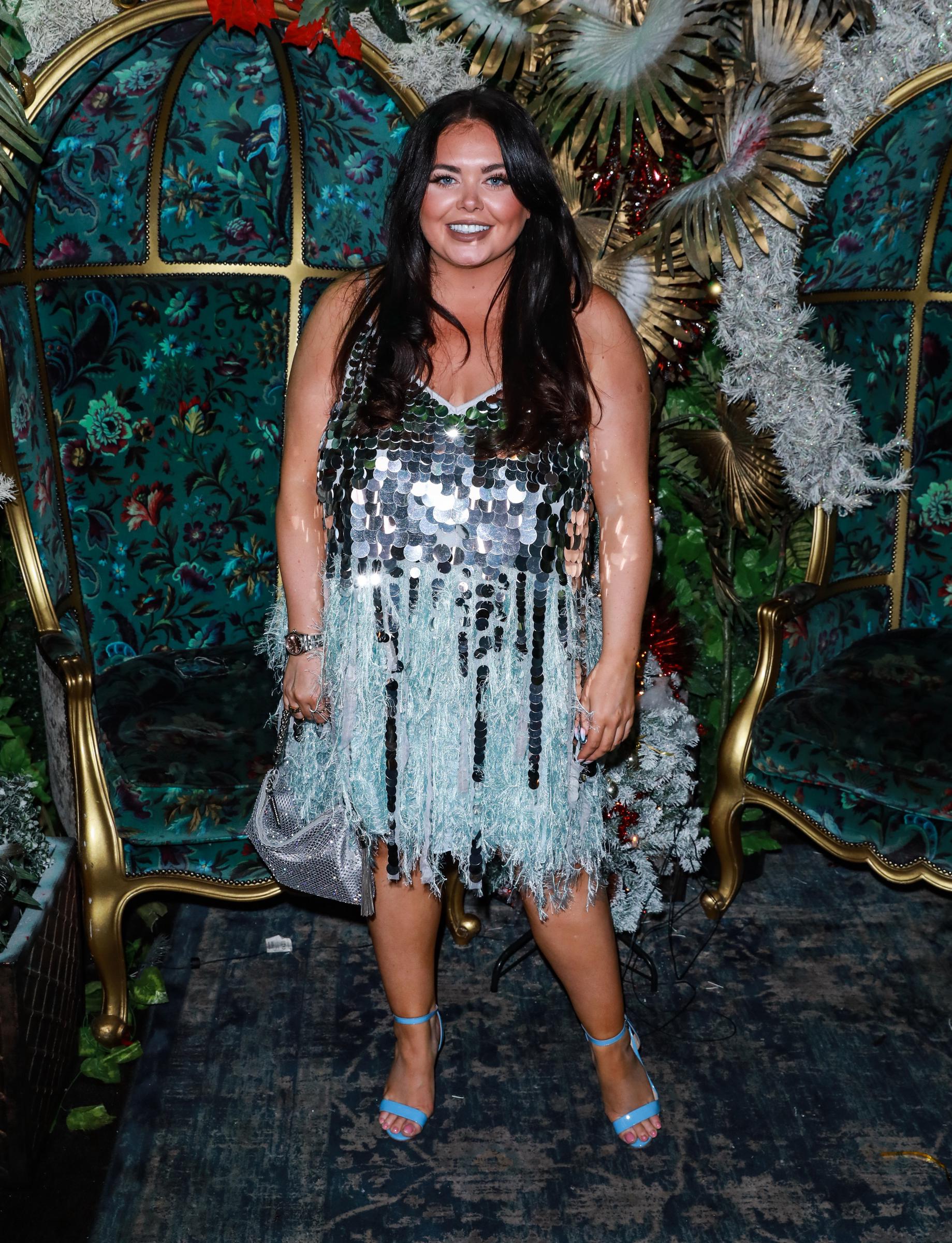 Moffatt rang in 2022 at the Cabaret All Stars New Year's Eve Show in London, dazzling in a silver disc-sequinned mini dress with pale blue feathered fringe trim, carrying a silver chainmail clutch and wearing blue ankle-strap sandals.