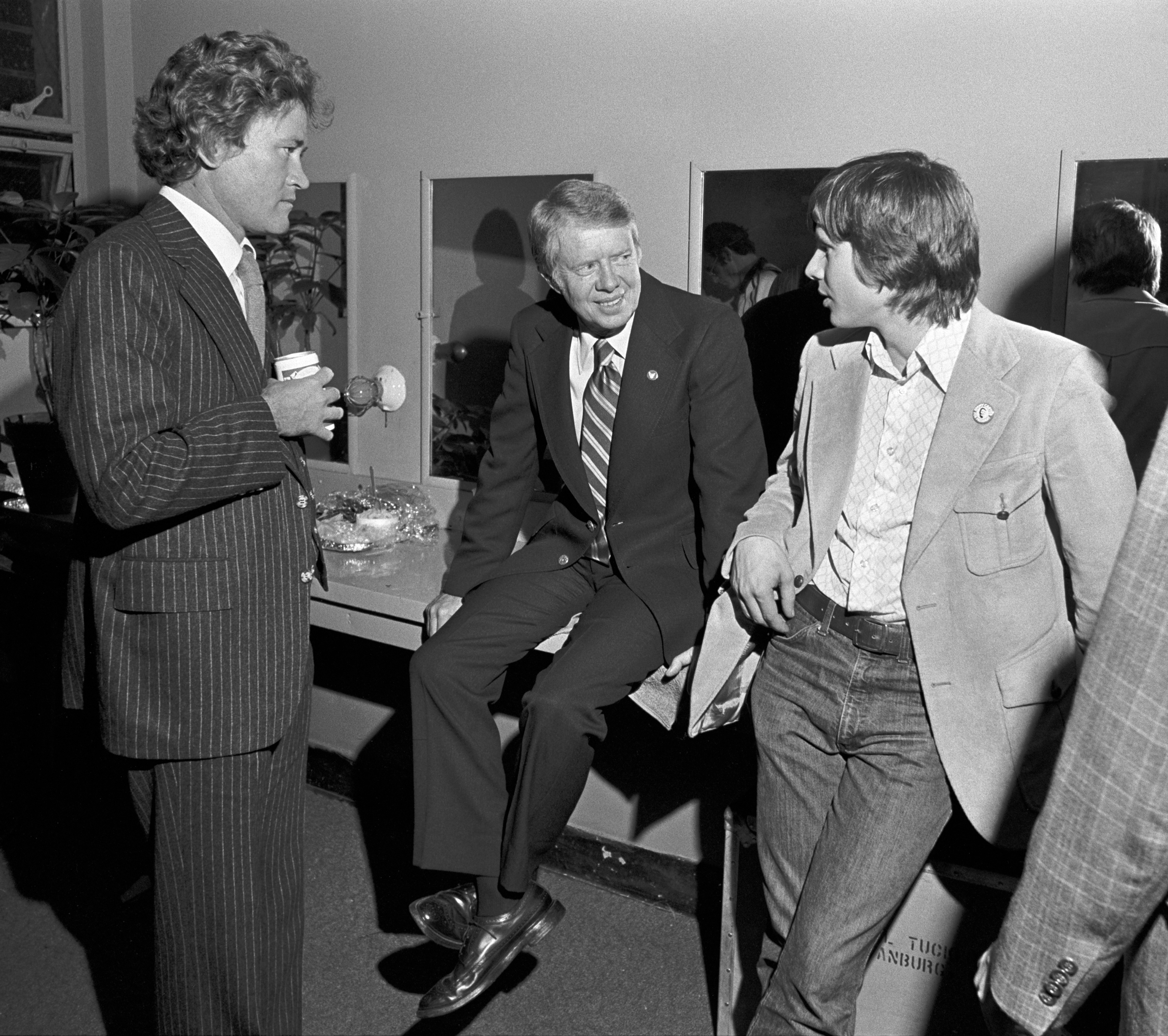 Phil Walden with Jimmy and Chip Carter in a dressing room after The Marshall Tucker Band benefit concert in Atlanta, Georgia on October 31, 1975 | Source: Getty Images