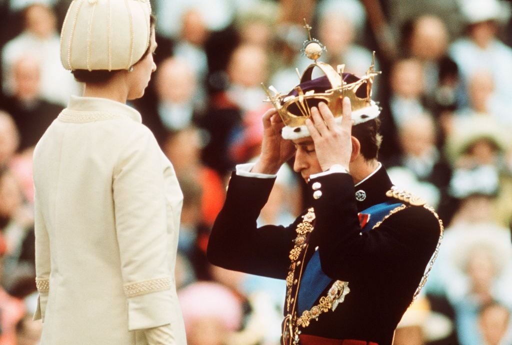 Prince Charles kneels before Queen Elizabeth as she crowns him Prince of Wales at the Investiture at Caernarvon Castle  | Getty Images