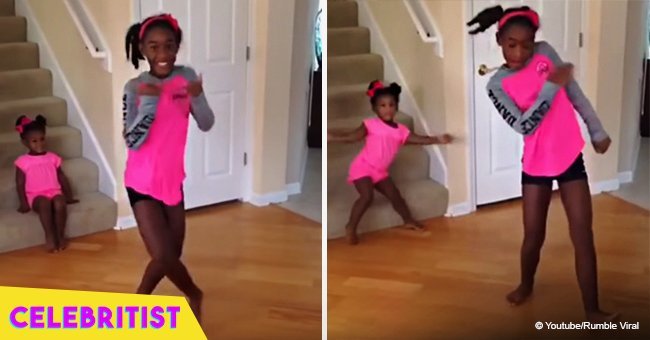 Toddler steals the show from big sister by dancing in the background in viral video