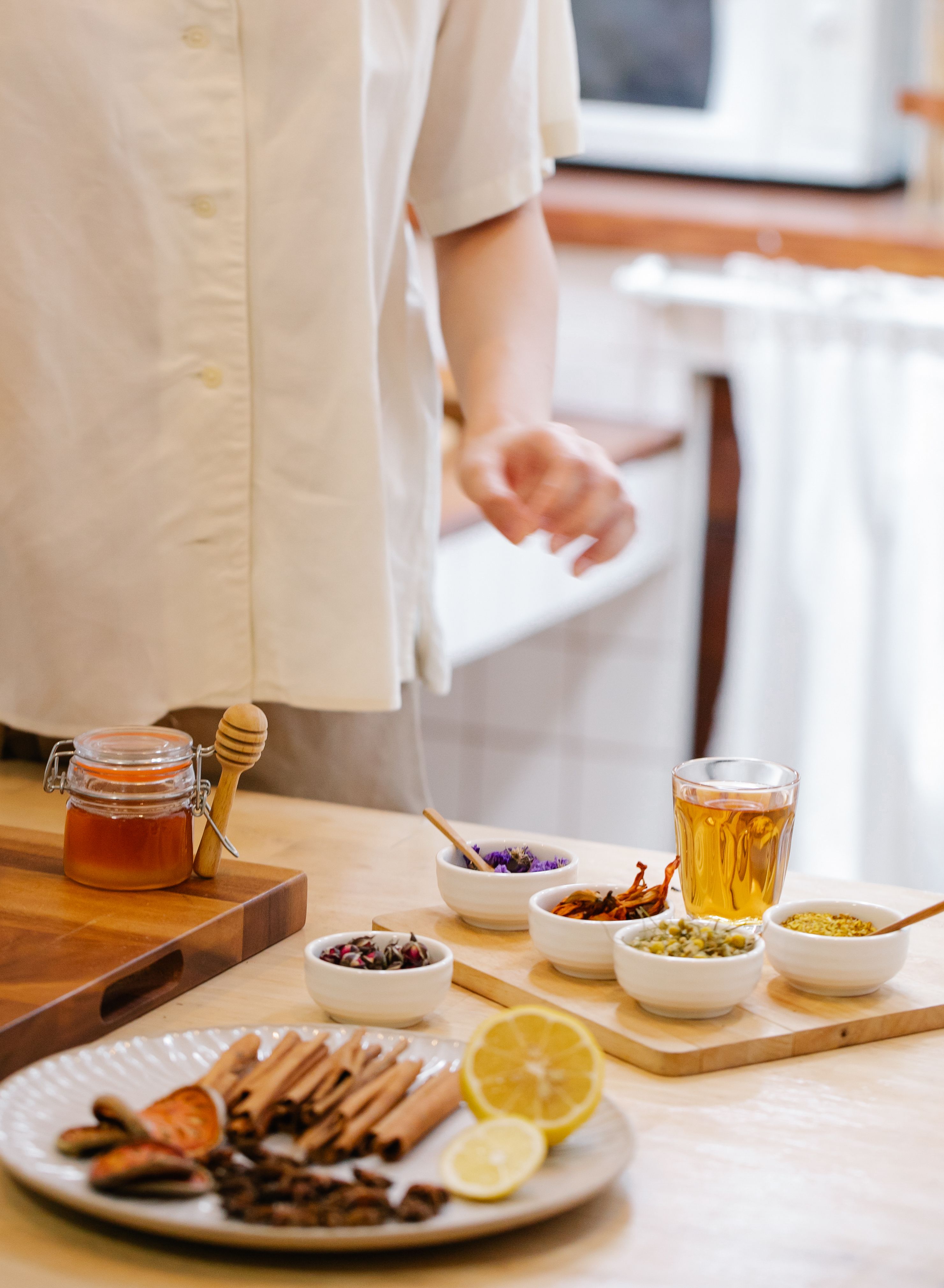 Bowls of spices and a jar of honey, ingredients for making herbal tea | Source: Pexels