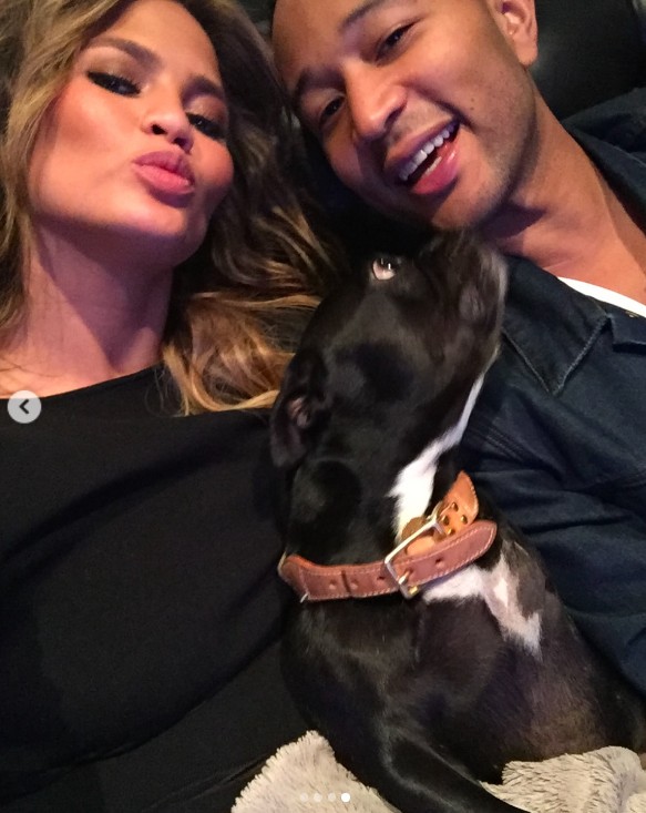 Chrissy Teigen and John Legend bolding during good times with their late dog, Penny, in a post dated January 26, 2025 | Source: Instagram/chrissyteigen