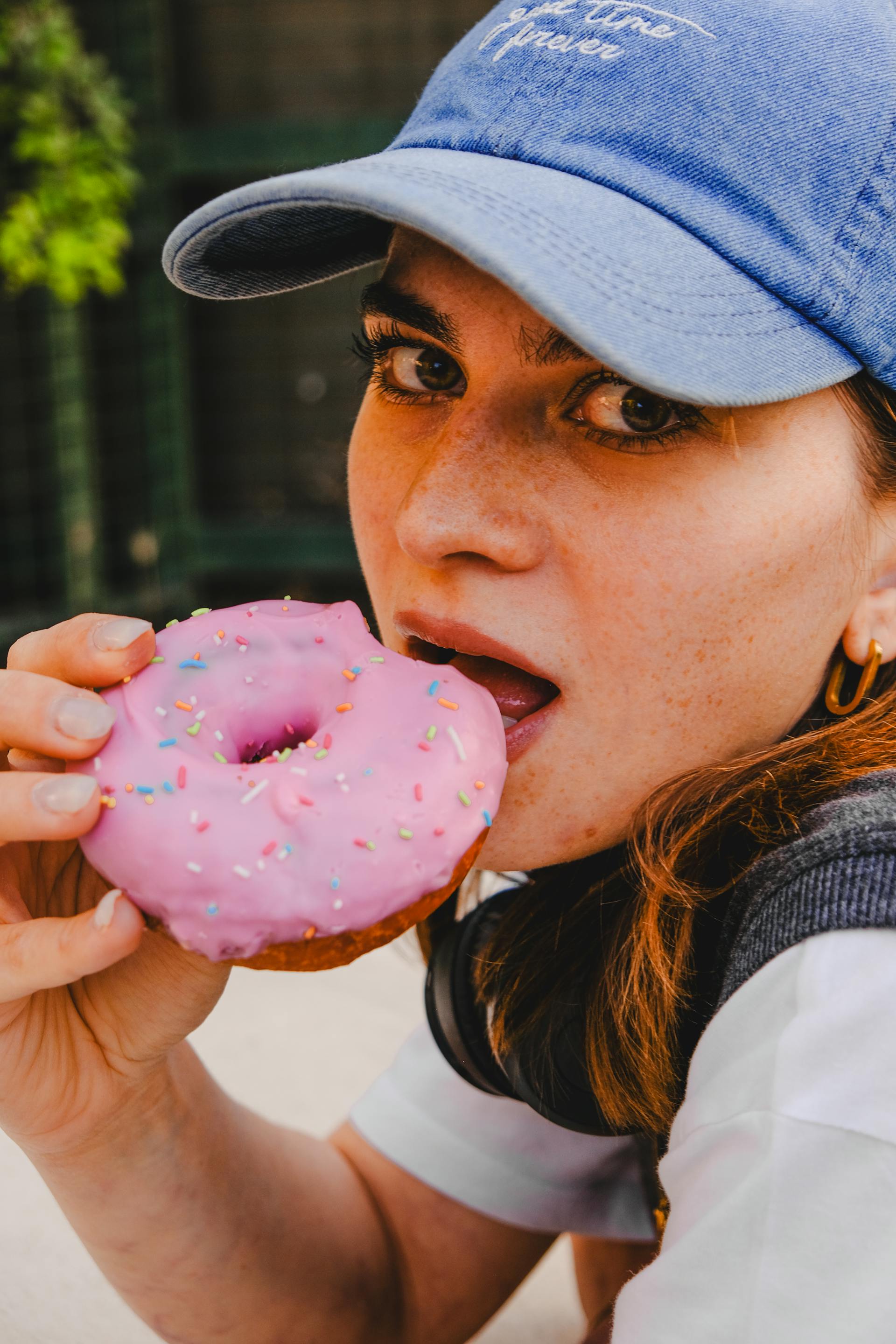 A closeup of a woman eating a donut | Source: Pexels