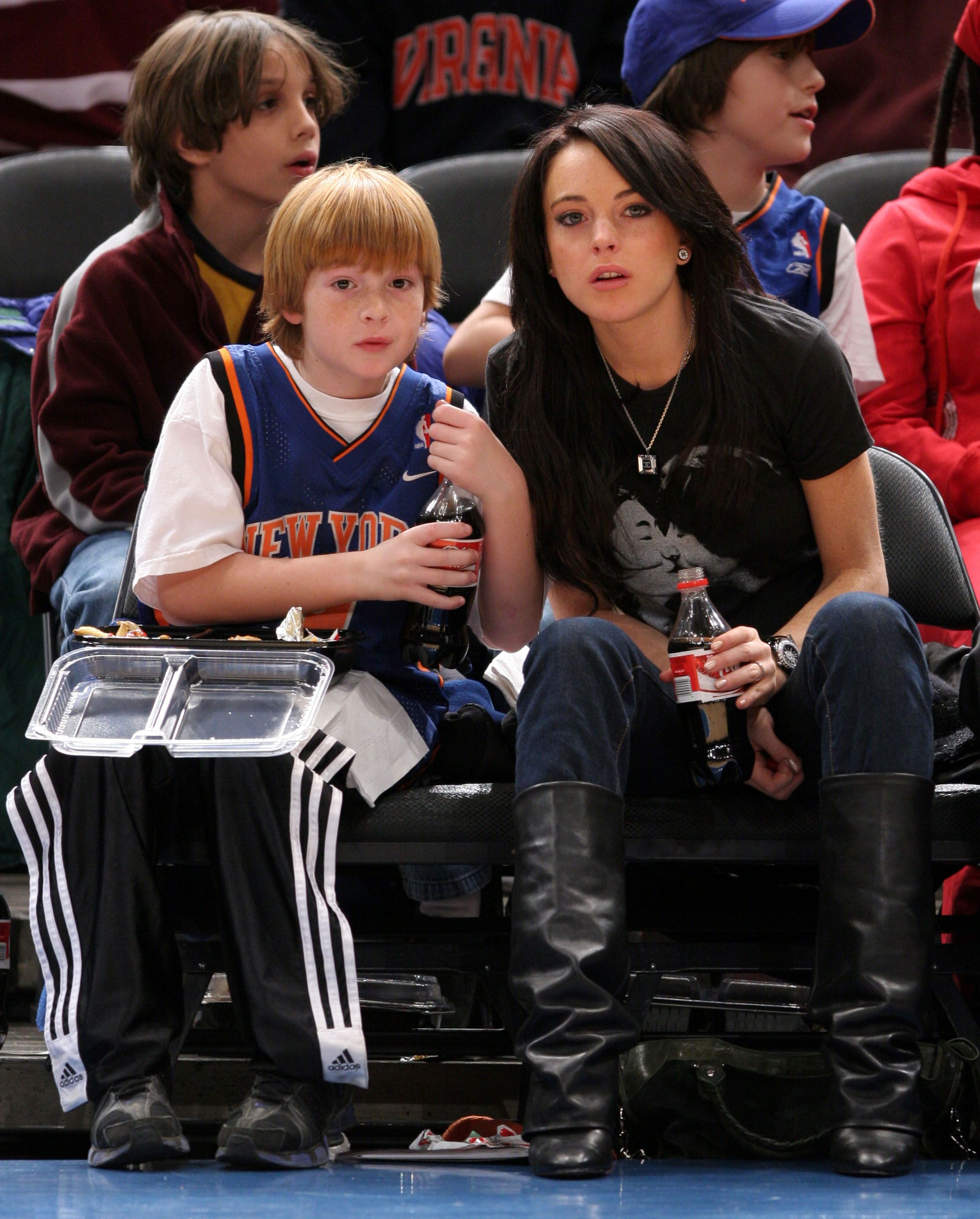 Dakota and Lindsay Lohan during the Utah Jazz vs New York Knicks Game - December 23, 2005 at Madison Square Garden in New York City, New York, United States. | Source: Getty Images