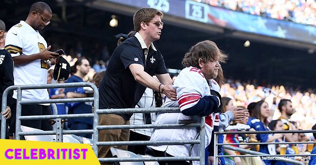 Saints fan helps disabled Giants fan stand for national anthem in viral photo