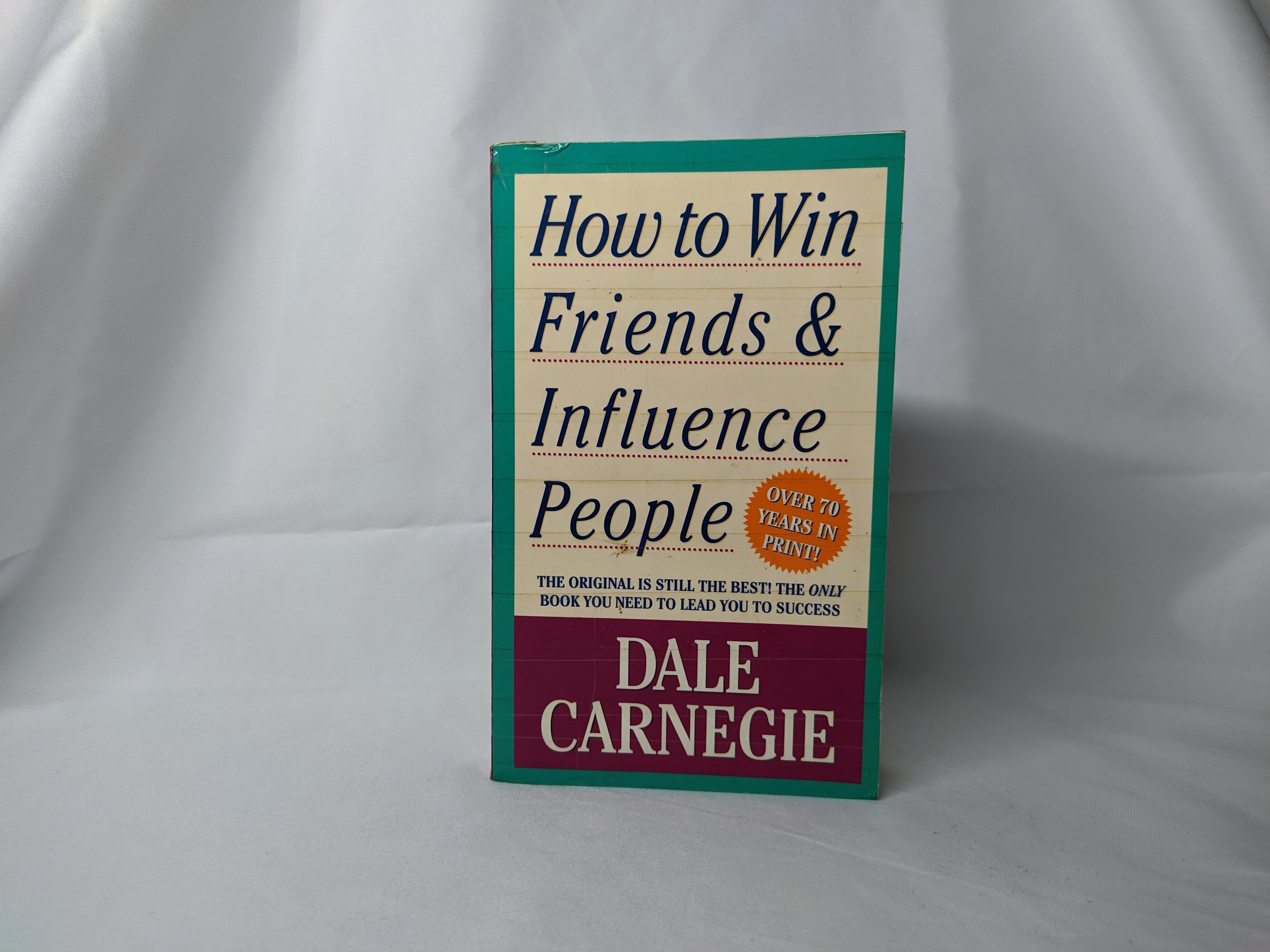 A copy of "How to Win Friends & Influence People" by Dale Carnegie on display | Source: Shutterstock