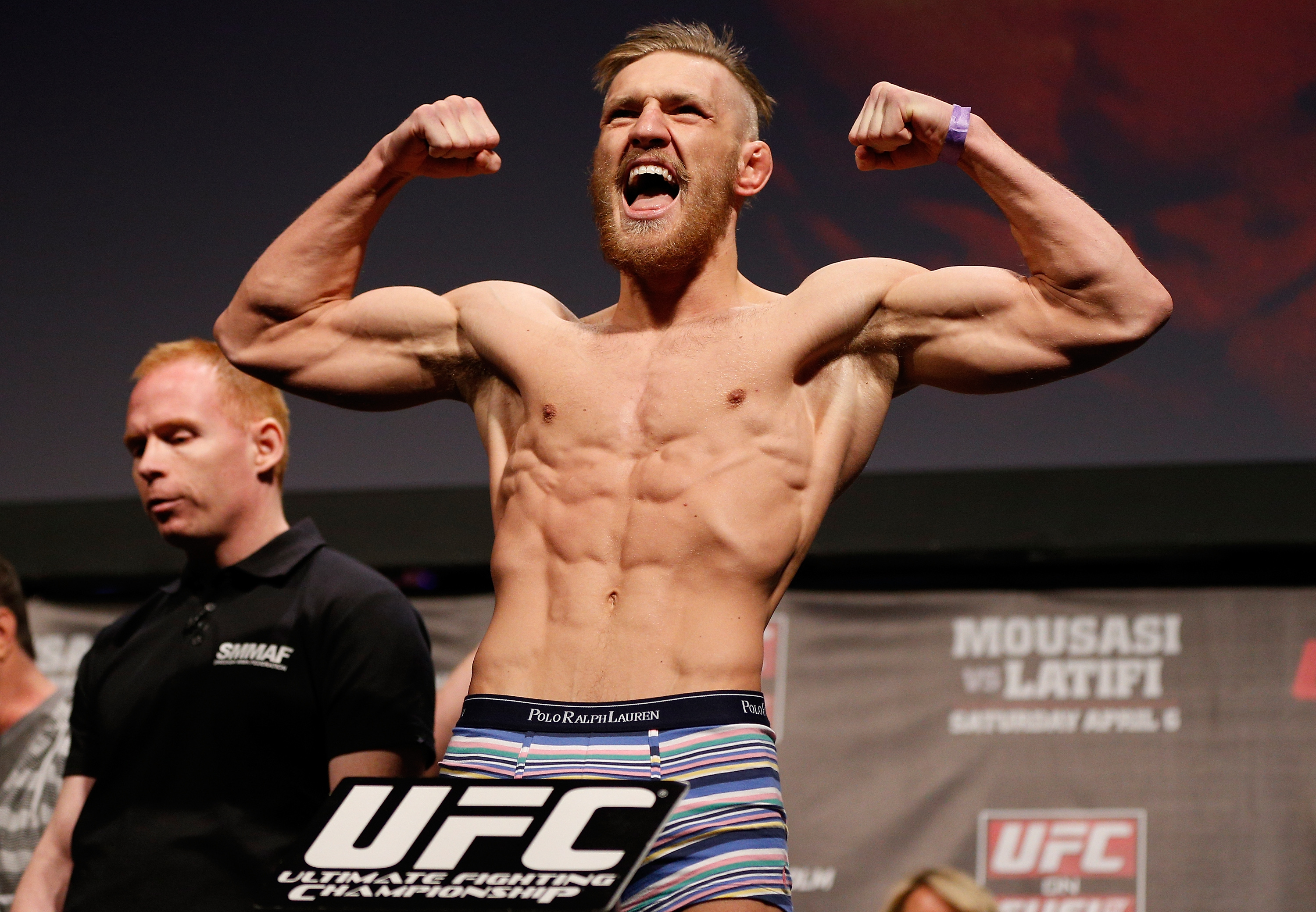Conor McGregor flexes during the UFC weigh-ins at Stockholm's Ericsson Globe Arena on April 5, 2013. Early in his UFC career, the future two-division champion competed as a featherweight, with his lean, highly defined physique reflecting the demanding weight cuts that became a hallmark of his rise through the division.