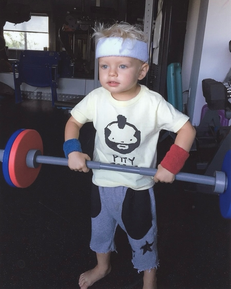 A throwback photo of Fergie's son Axl Duhamel dressed as a weight-lifter, from her birthday tribute posted on August 29, 2025 | Source: Instagram/fergie