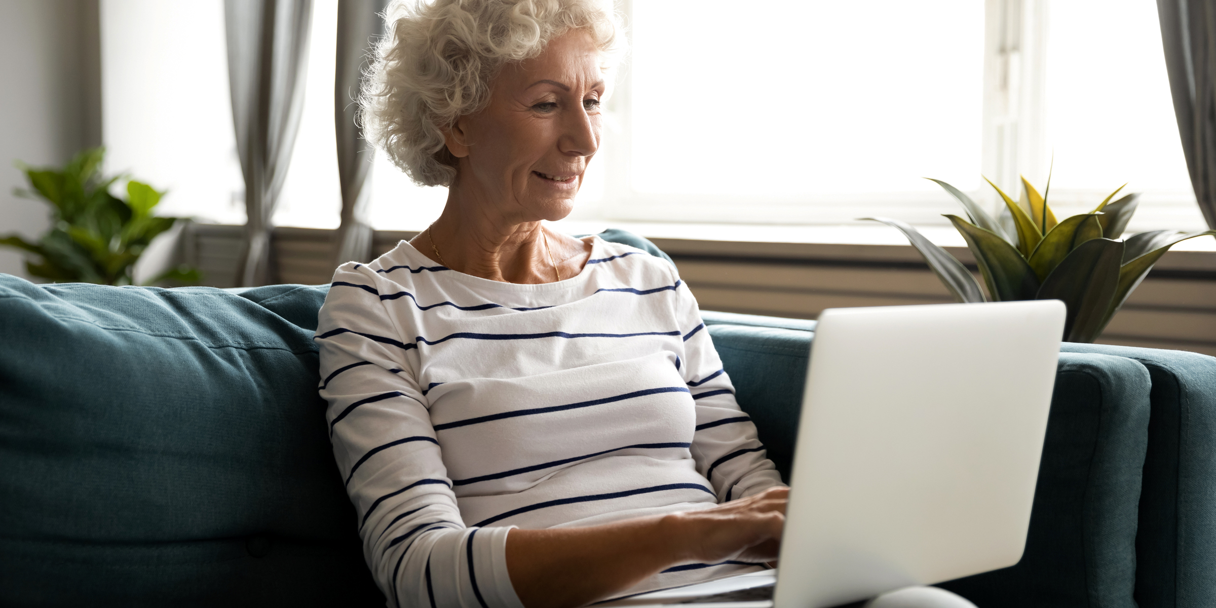 Elderly lady with her laptop | Source: Shutterstock
