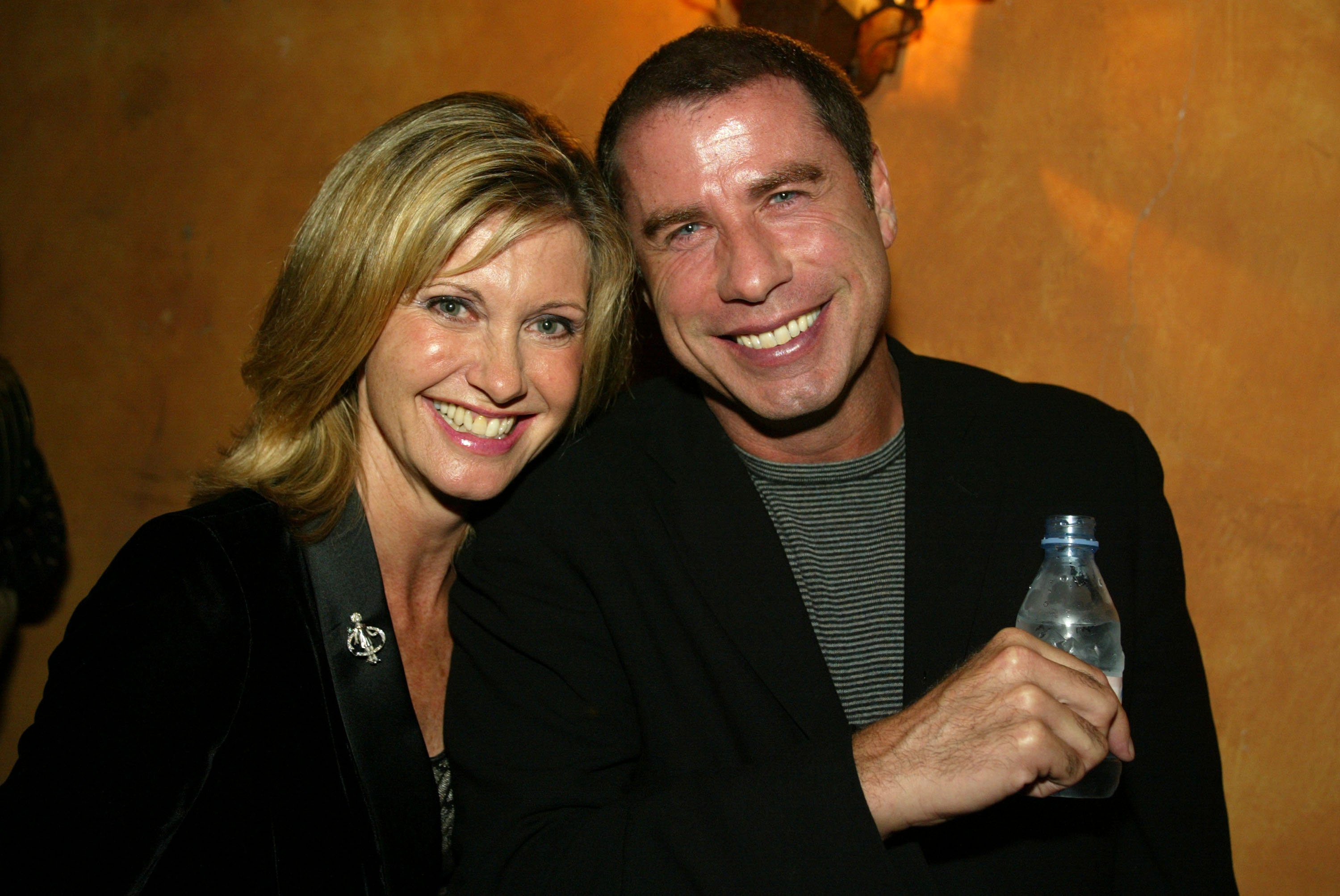 Olivia Newton-John and John Travolta at "One World, One Child Benefit Concert" for the Children's Health Environmental Coalition (CHEC) honoring Meryl Streep, Nell Newman, and Dr. Lawrie Mott at the home of Cindra and Alan Ladd in Beverly Hills, on Thursday, October 10, 2002. | Source: Getty Images
